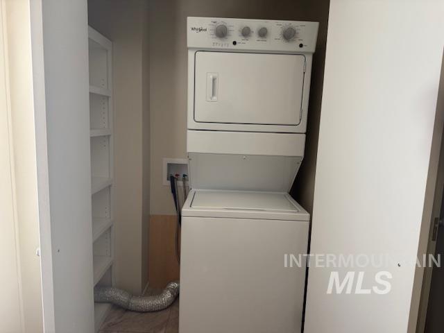 Laundry area featuring stacked washer and clothes dryer