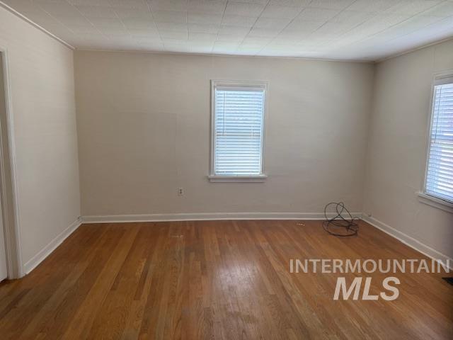 Spare room with wood finished floors and baseboards