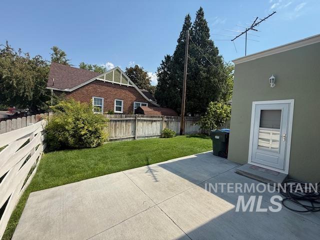 Fenced backyard with a patio area