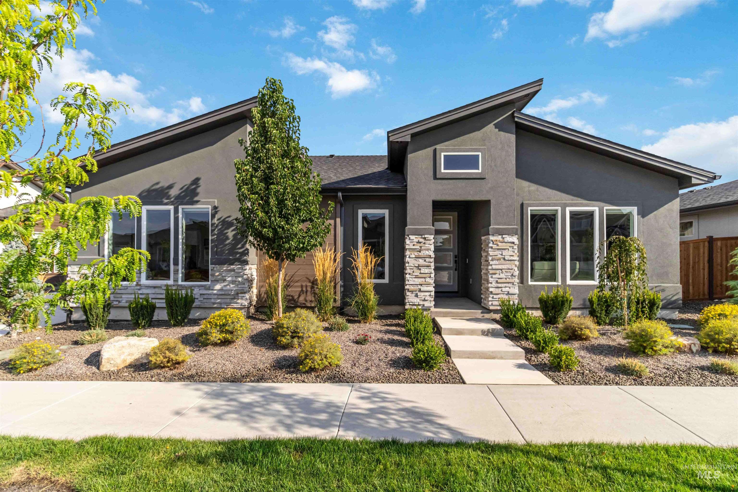 View of front of home with stucco siding and stone siding