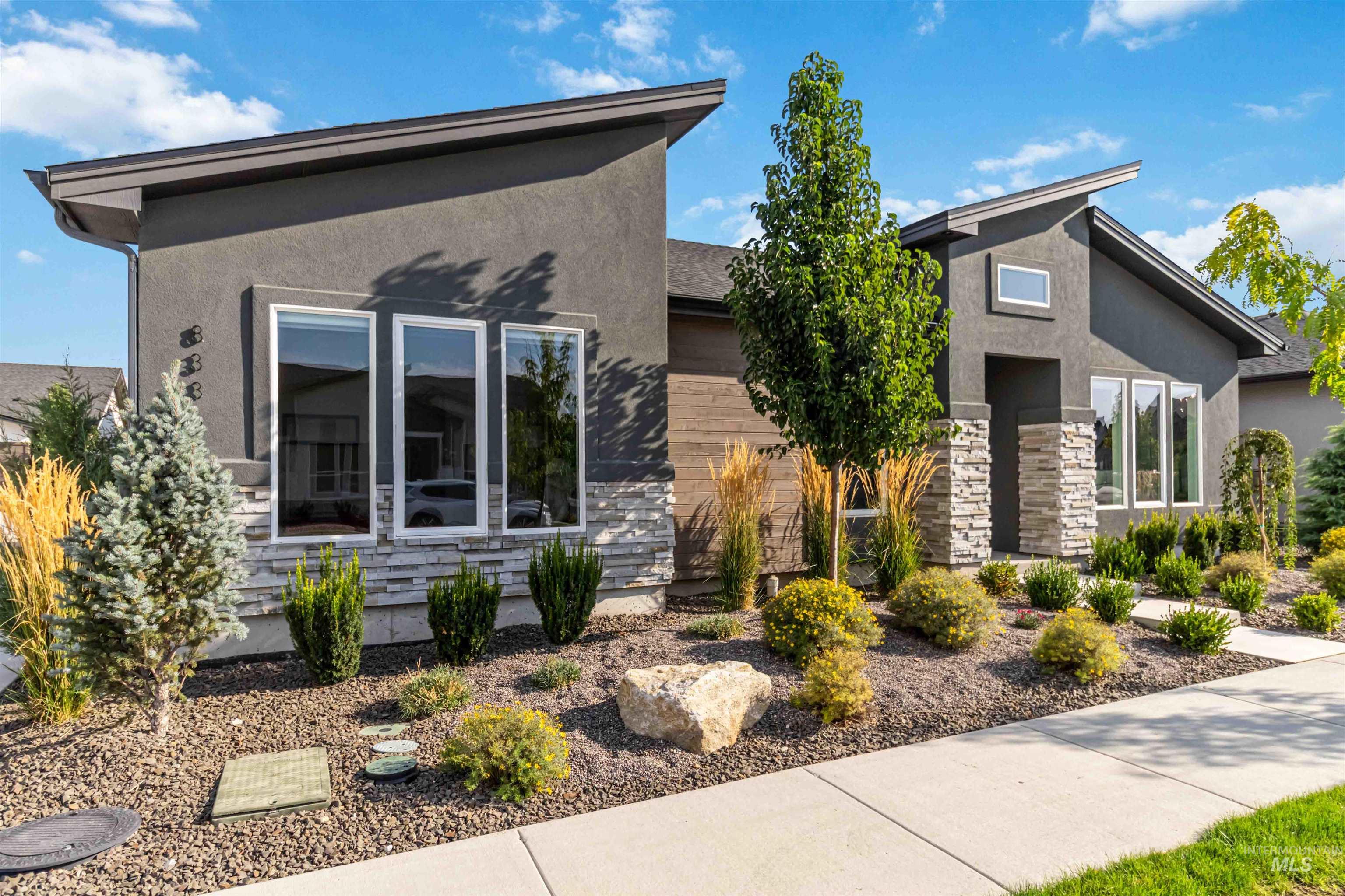 View of front of property featuring stone siding and stucco siding