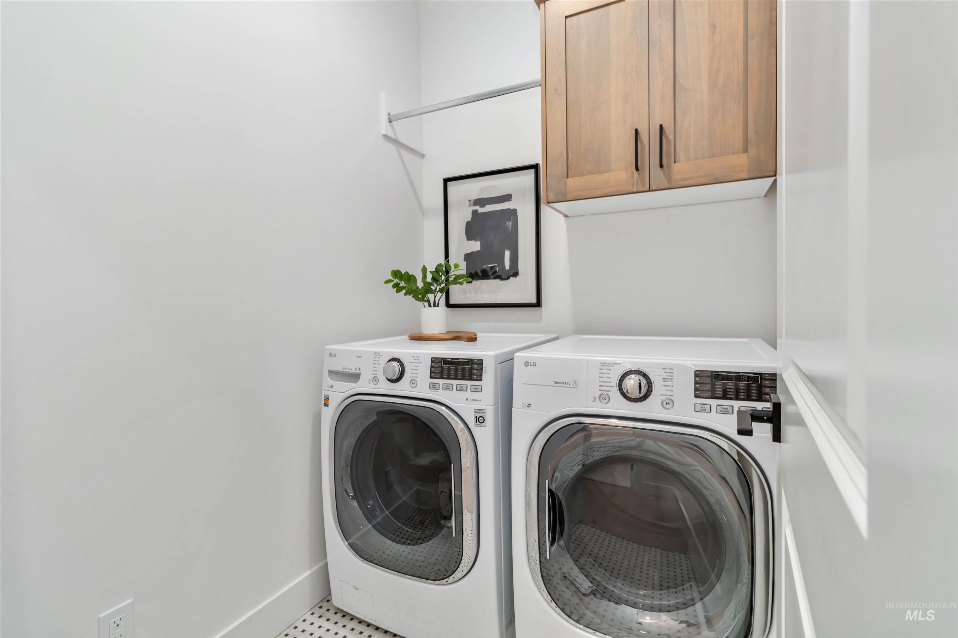 Laundry area with washer and dryer and cabinet space