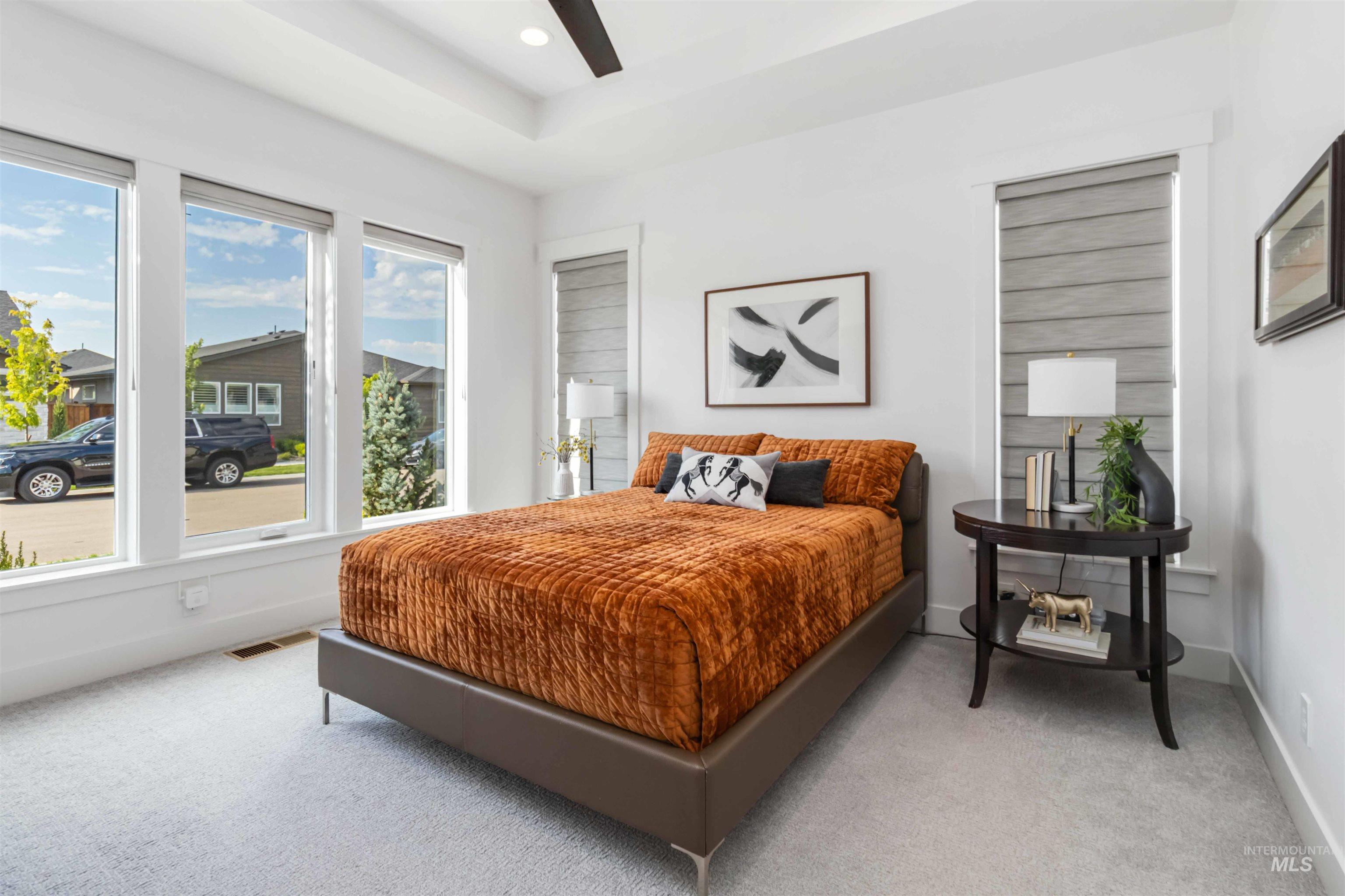 Bedroom featuring carpet flooring, a ceiling fan, recessed lighting, and a raised ceiling