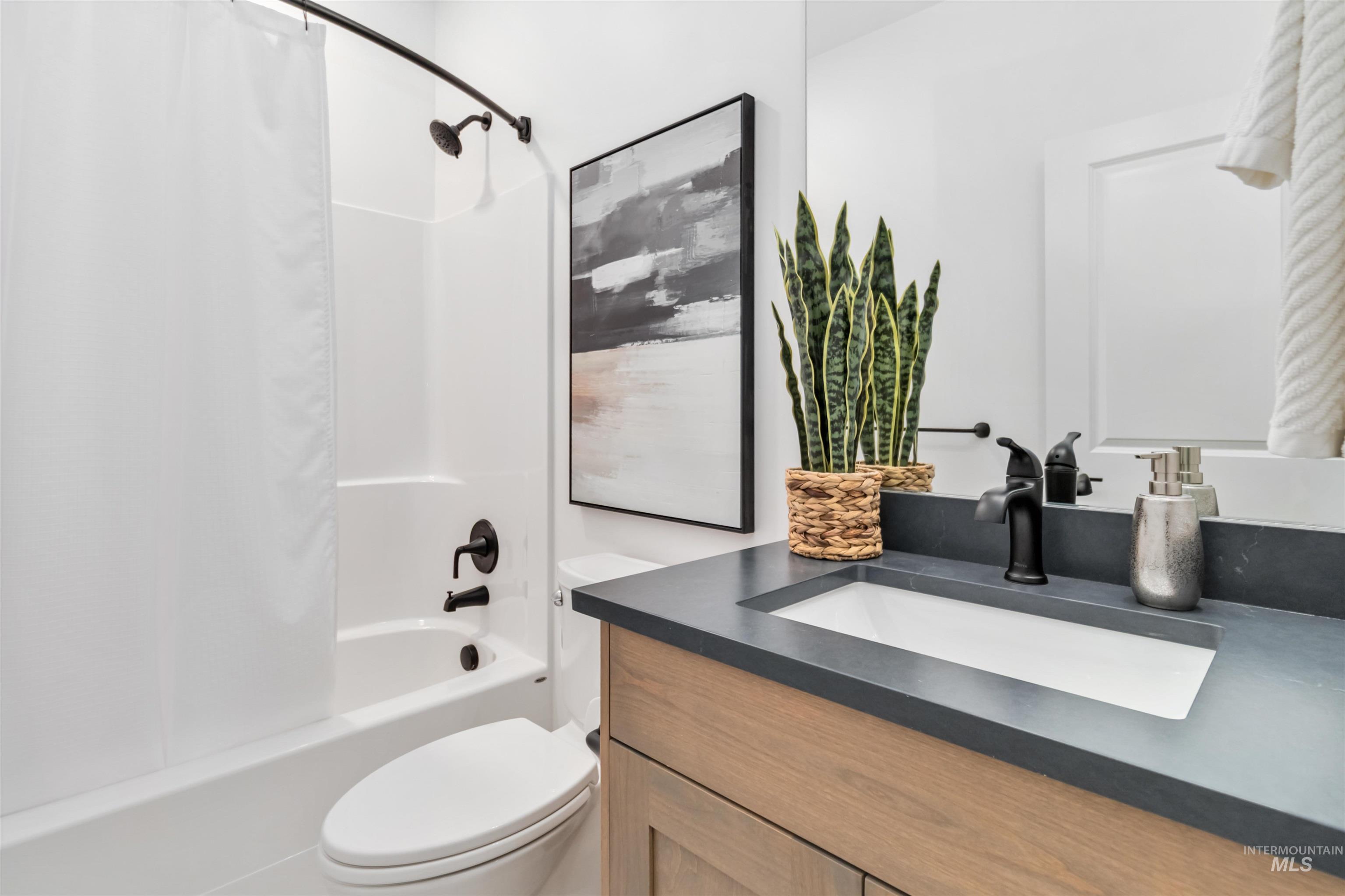 Full bathroom with shower / tub combo and vanity