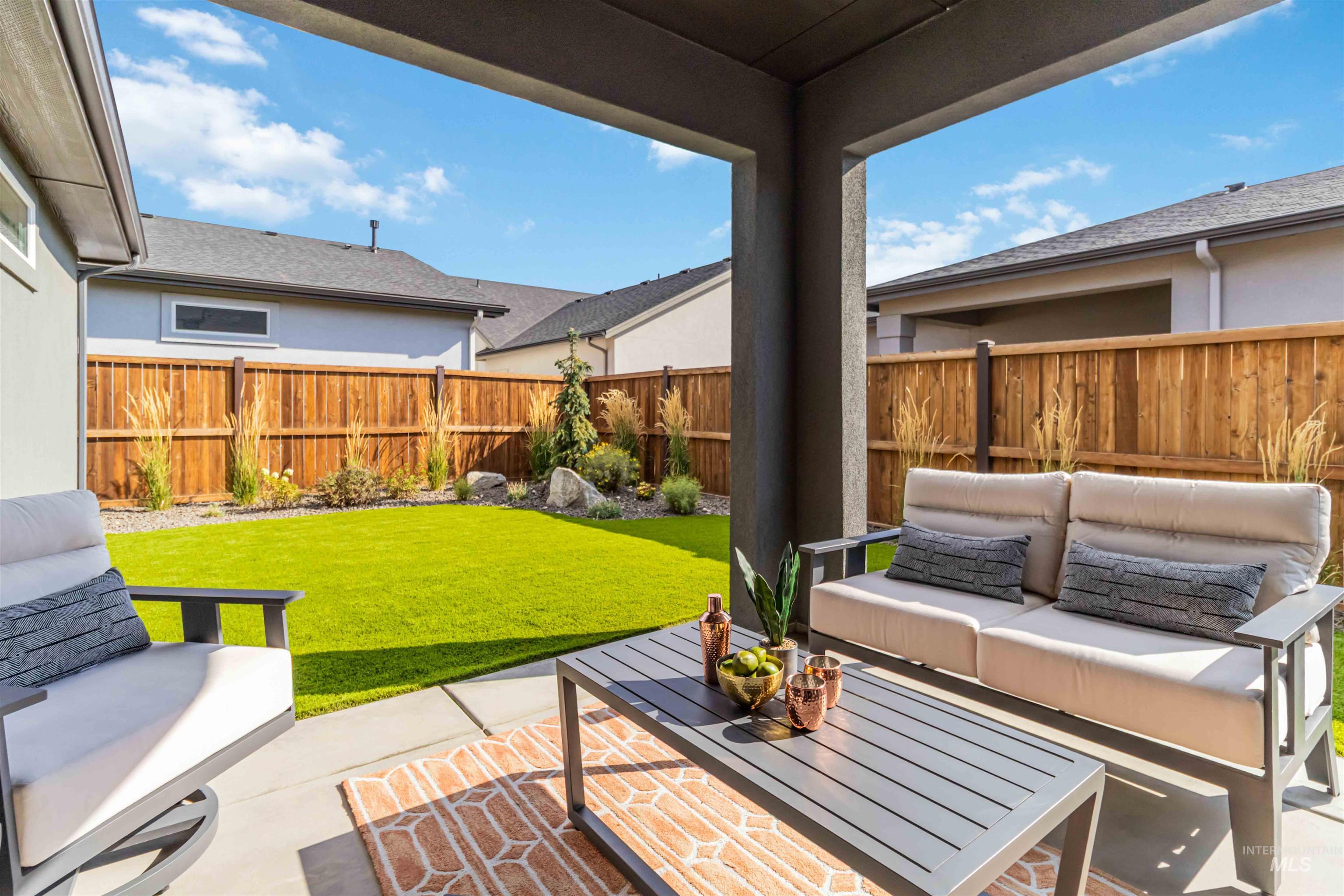 Fenced backyard with an outdoor hangout area and a patio area