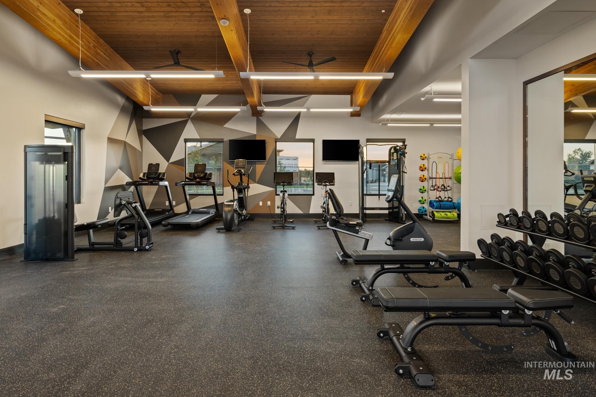 Workout area featuring a wood ceiling with exposed beams