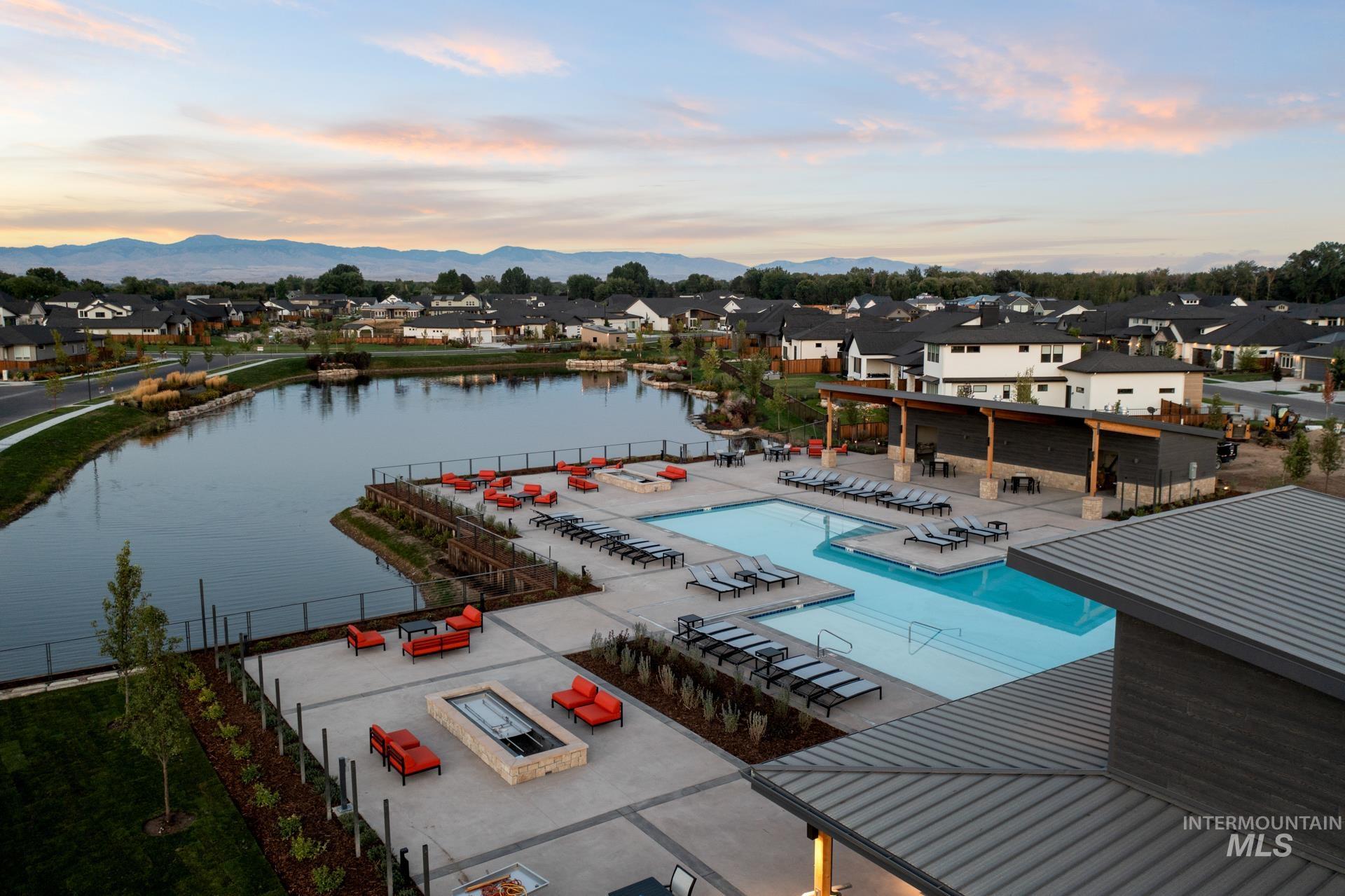 Aerial view of residential area with a large body of water and a pool area