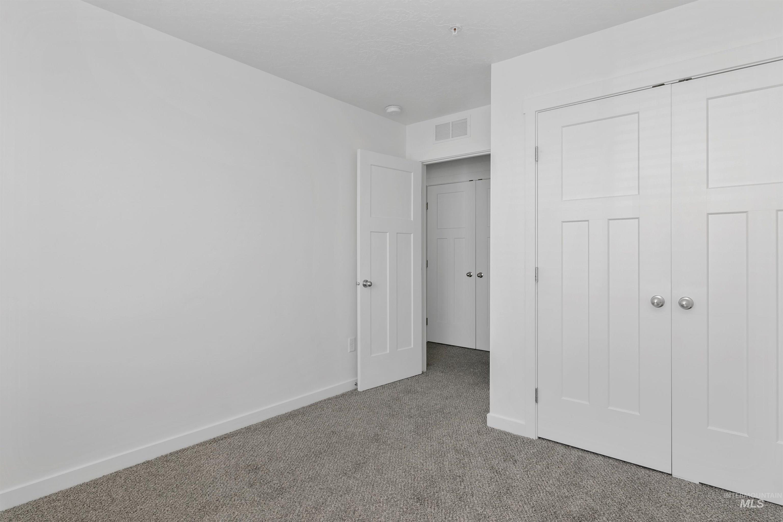 Unfurnished bedroom featuring carpet floors and a closet