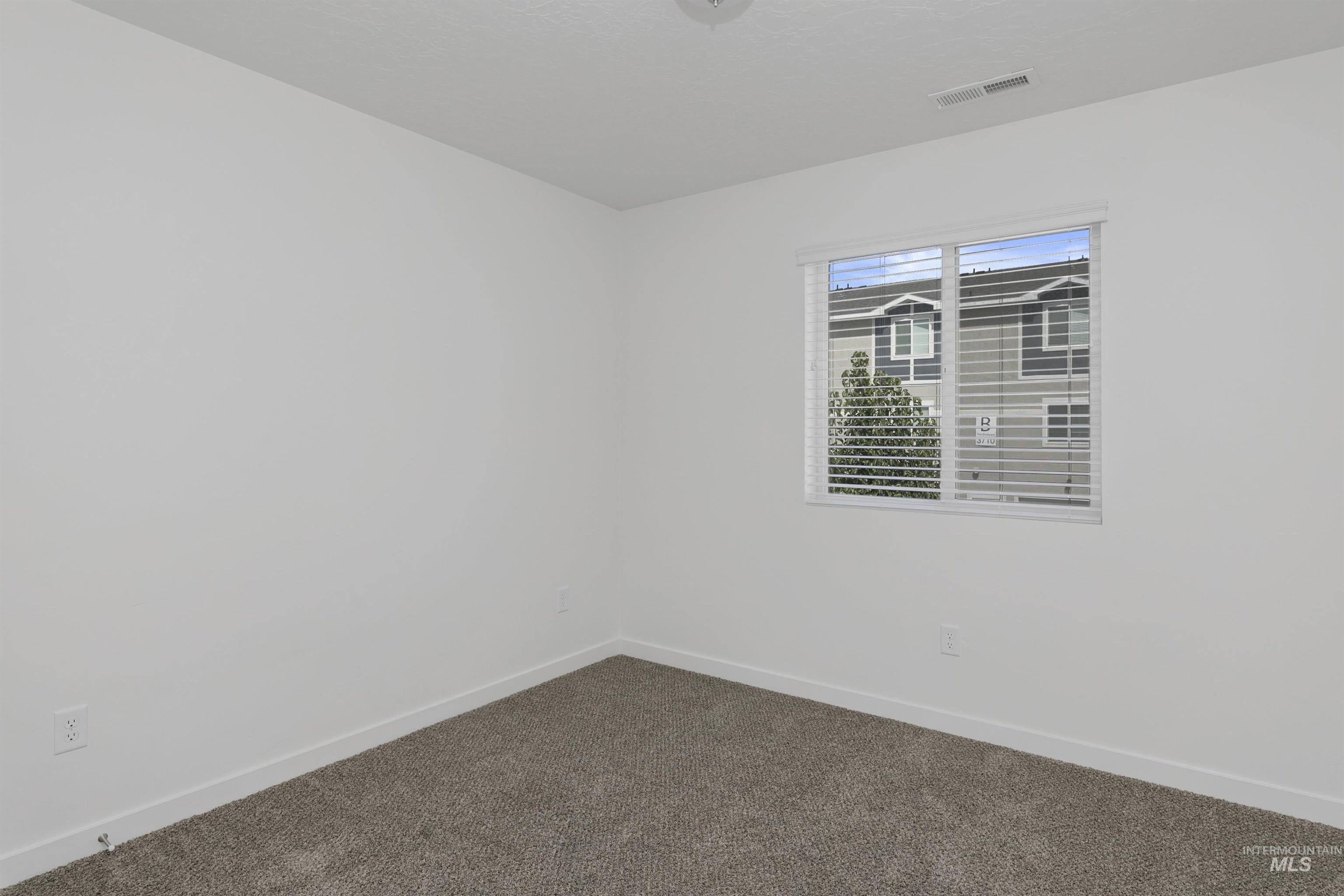 Unfurnished room featuring baseboards and carpet