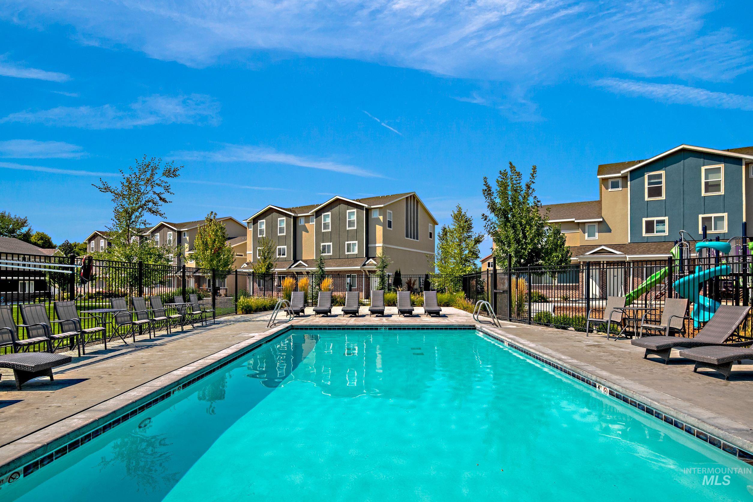 Community pool featuring a patio and a residential view