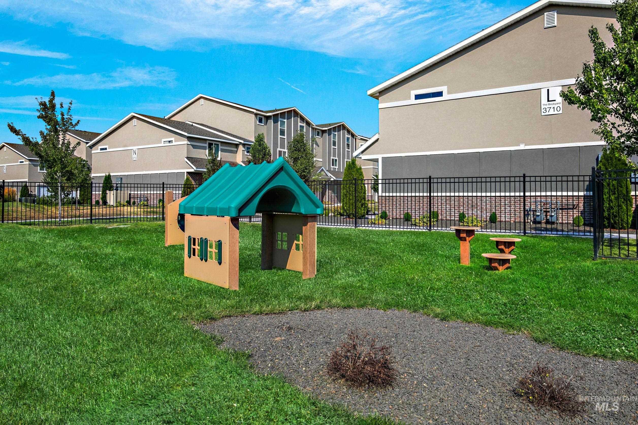 View of jungle gym with a dog friendly area and a residential view