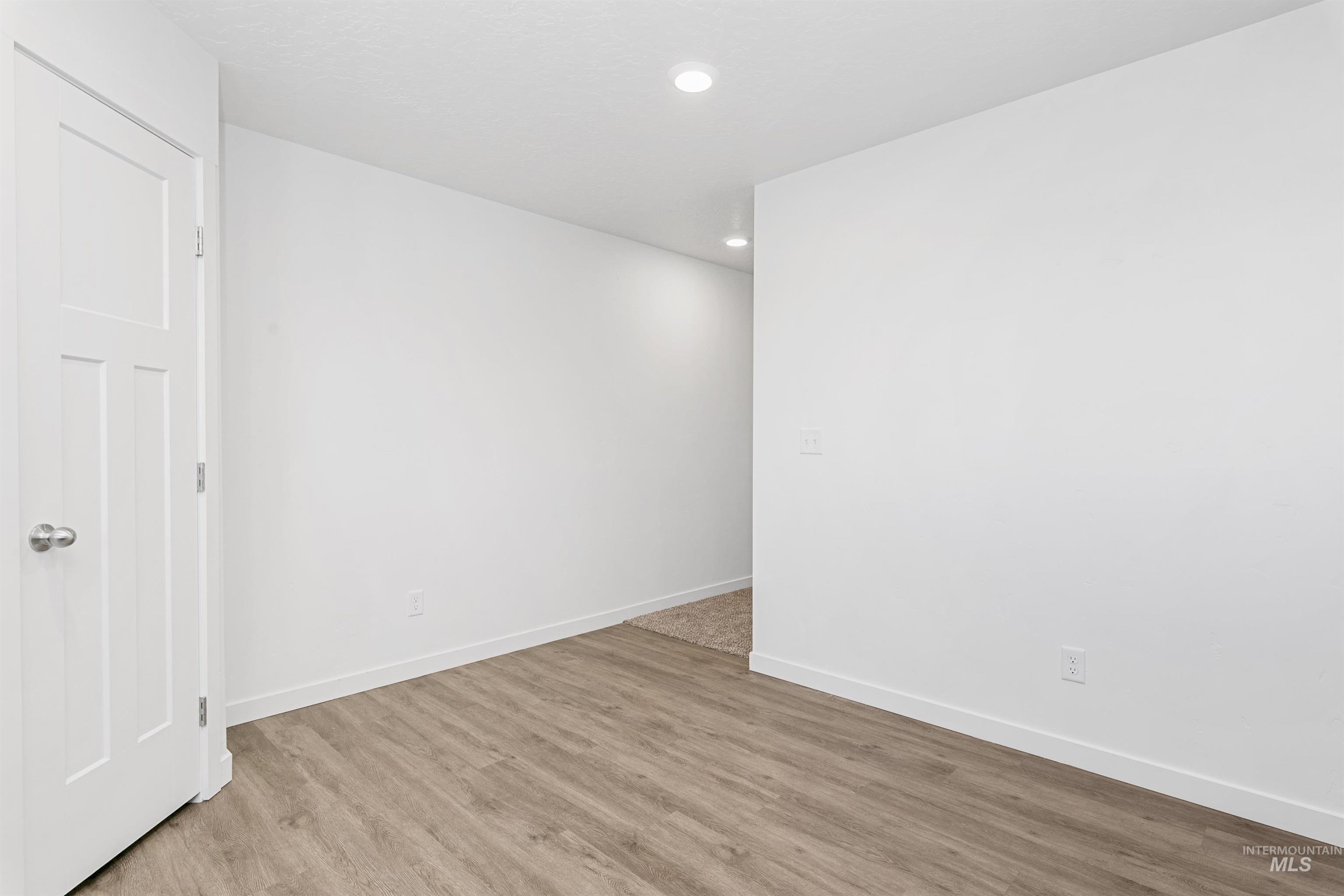 Spare room featuring wood finished floors and recessed lighting