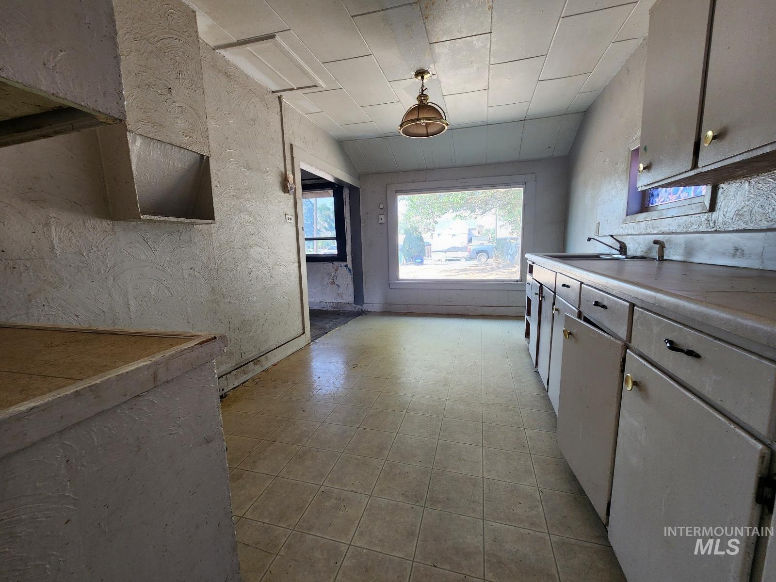 Kitchen featuring light countertops and a textured wall
