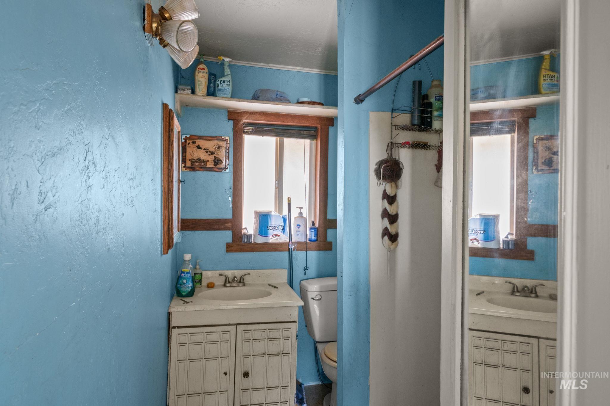 Full bath featuring vanity and toilet