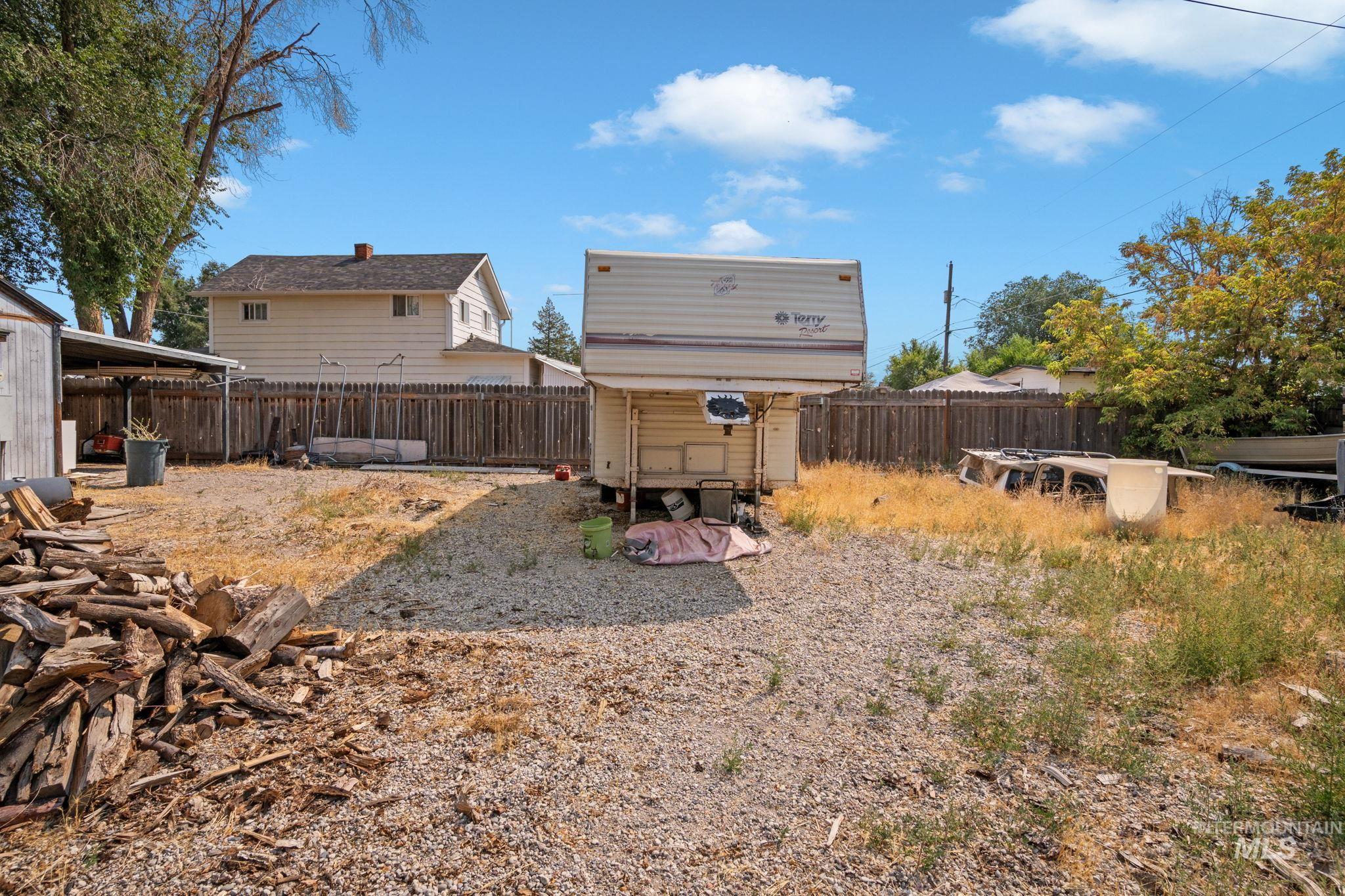 Fenced backyard with an outdoor structure