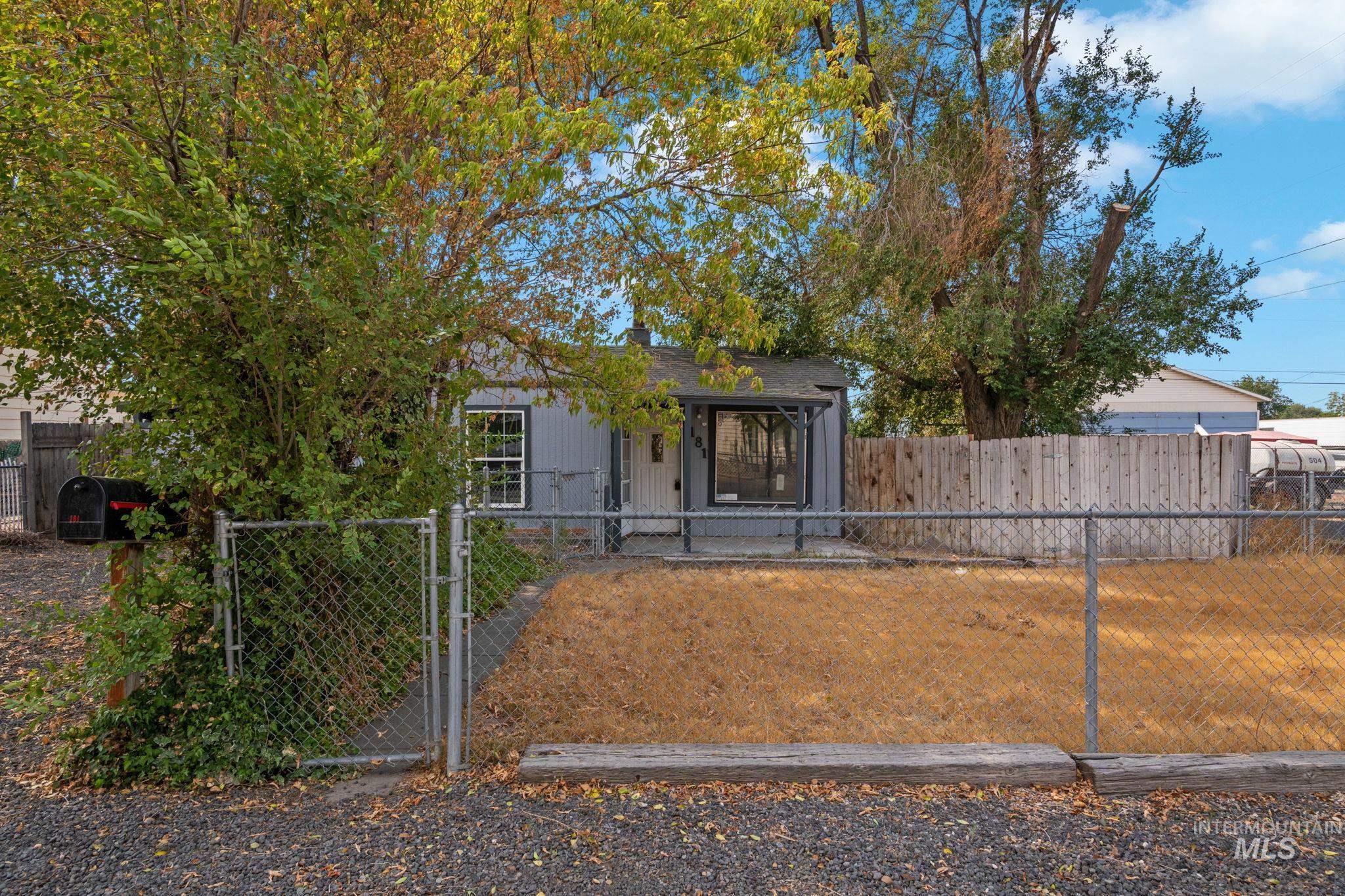 View of front of house featuring a gate and a fenced front yard