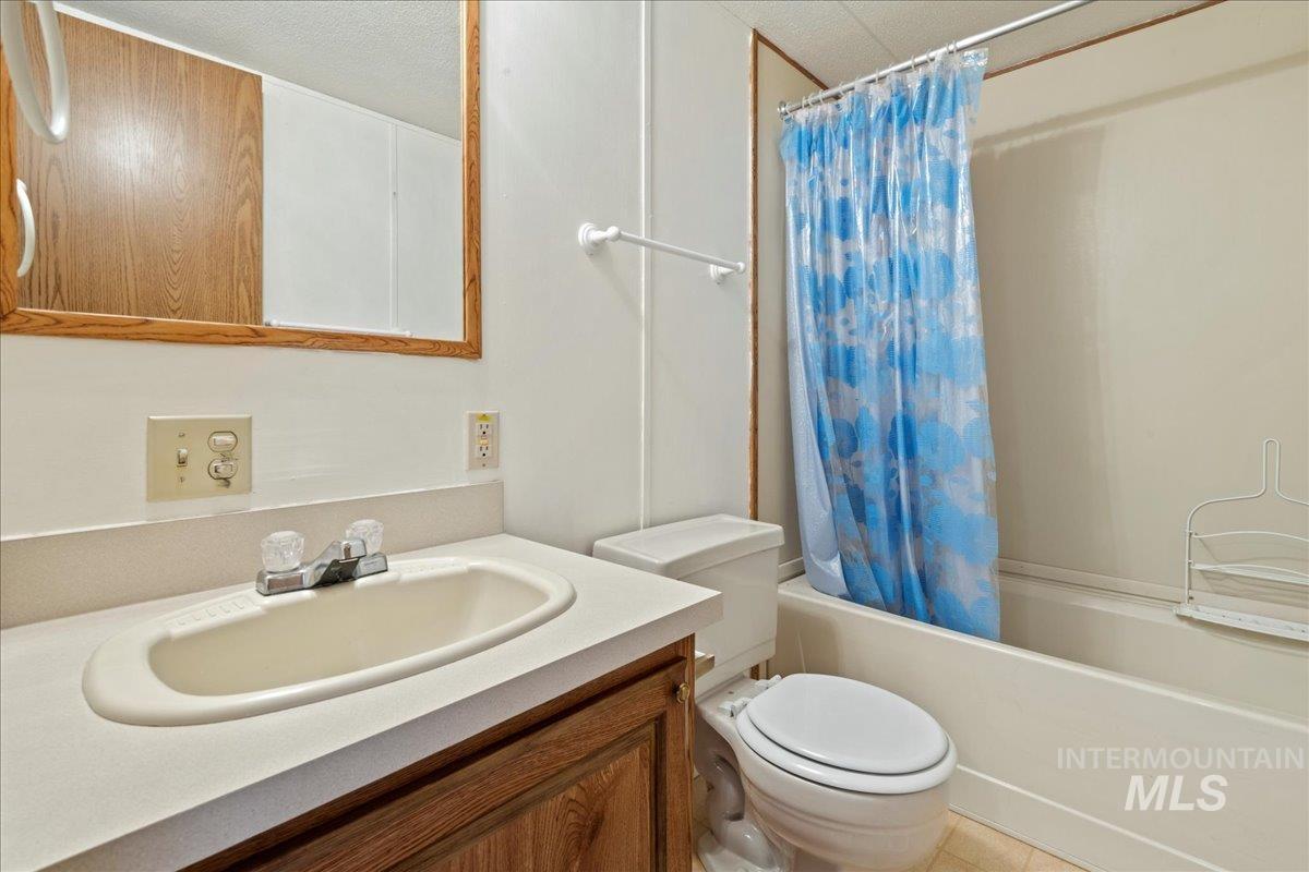 Full bathroom featuring shower / bath combo and vanity