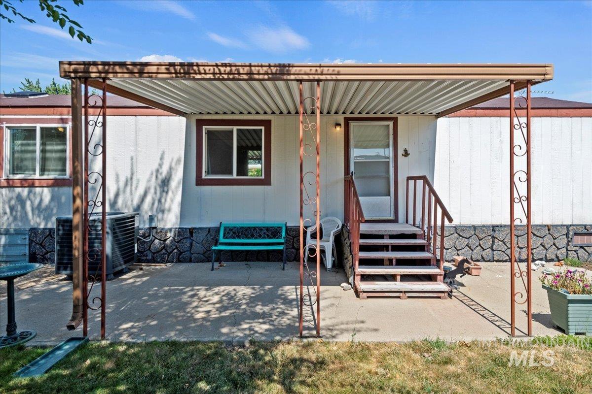 Rear view of property featuring a patio area