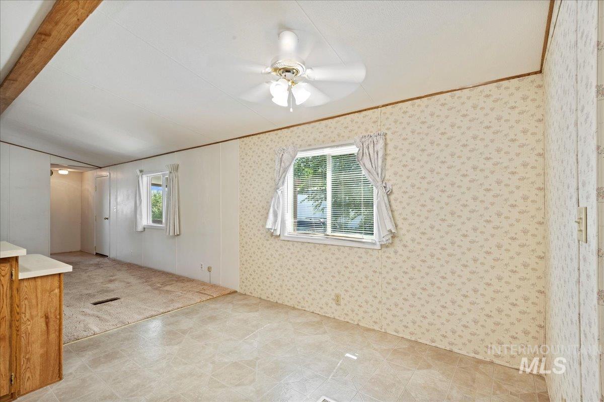 Spare room with crown molding and ceiling fan