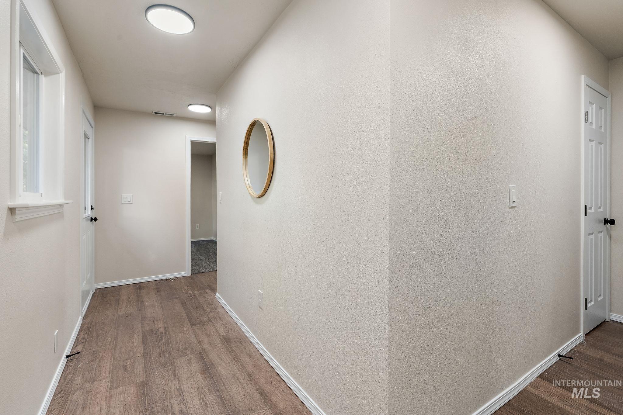 Corridor featuring dark wood-type flooring