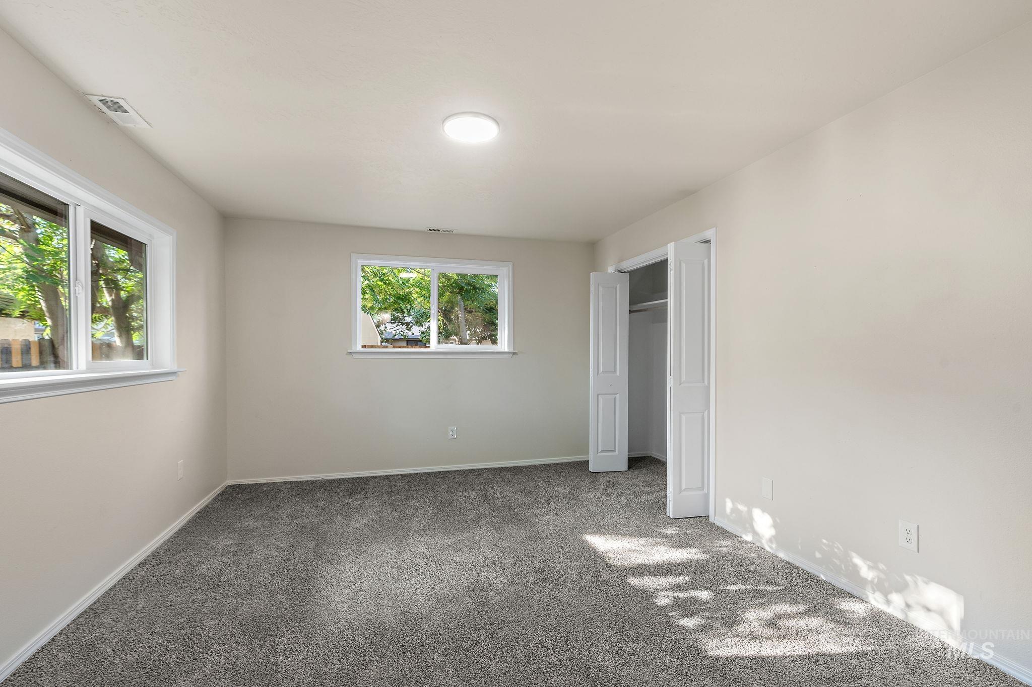 Unfurnished bedroom featuring carpet and a closet