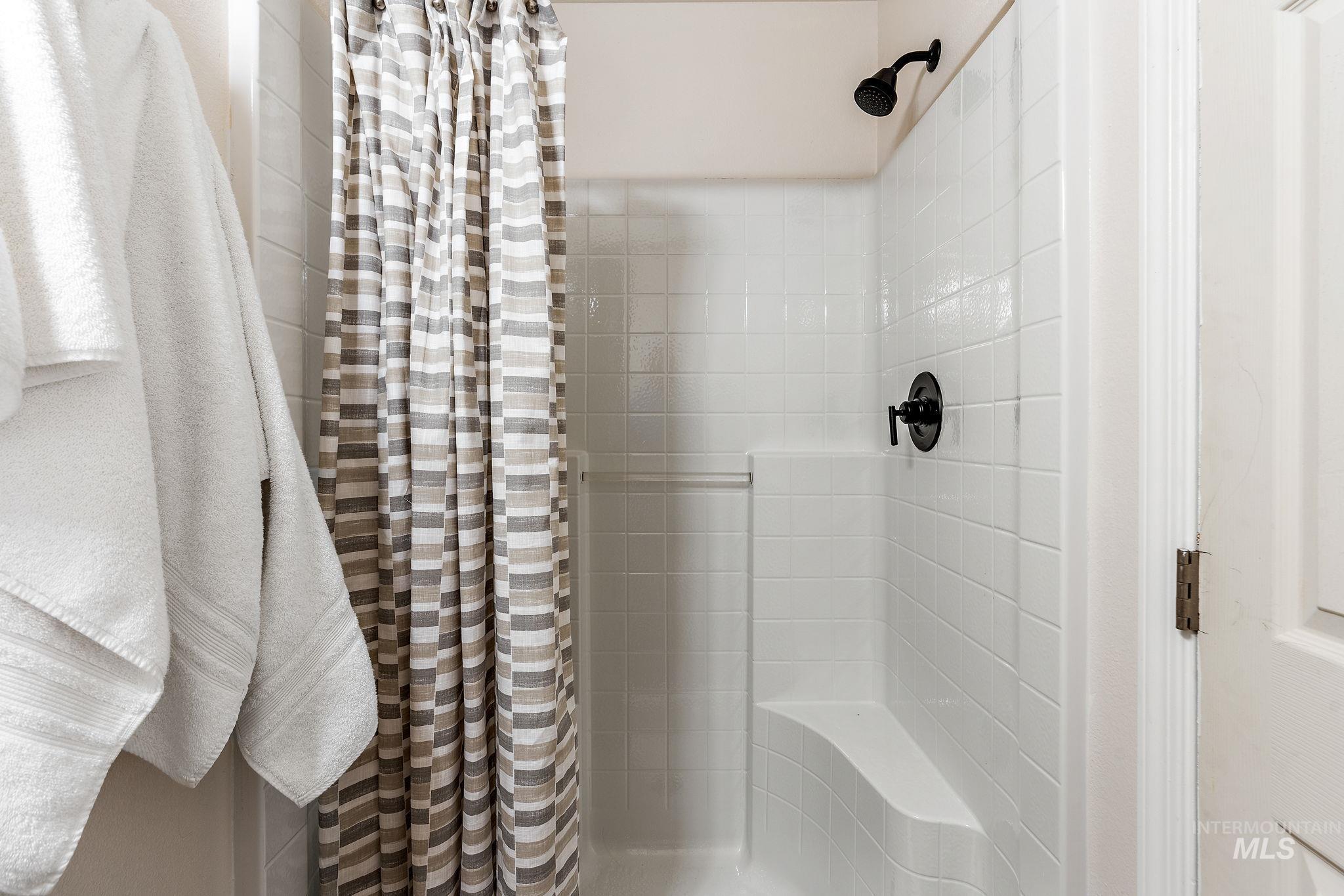 Bathroom featuring tiled shower