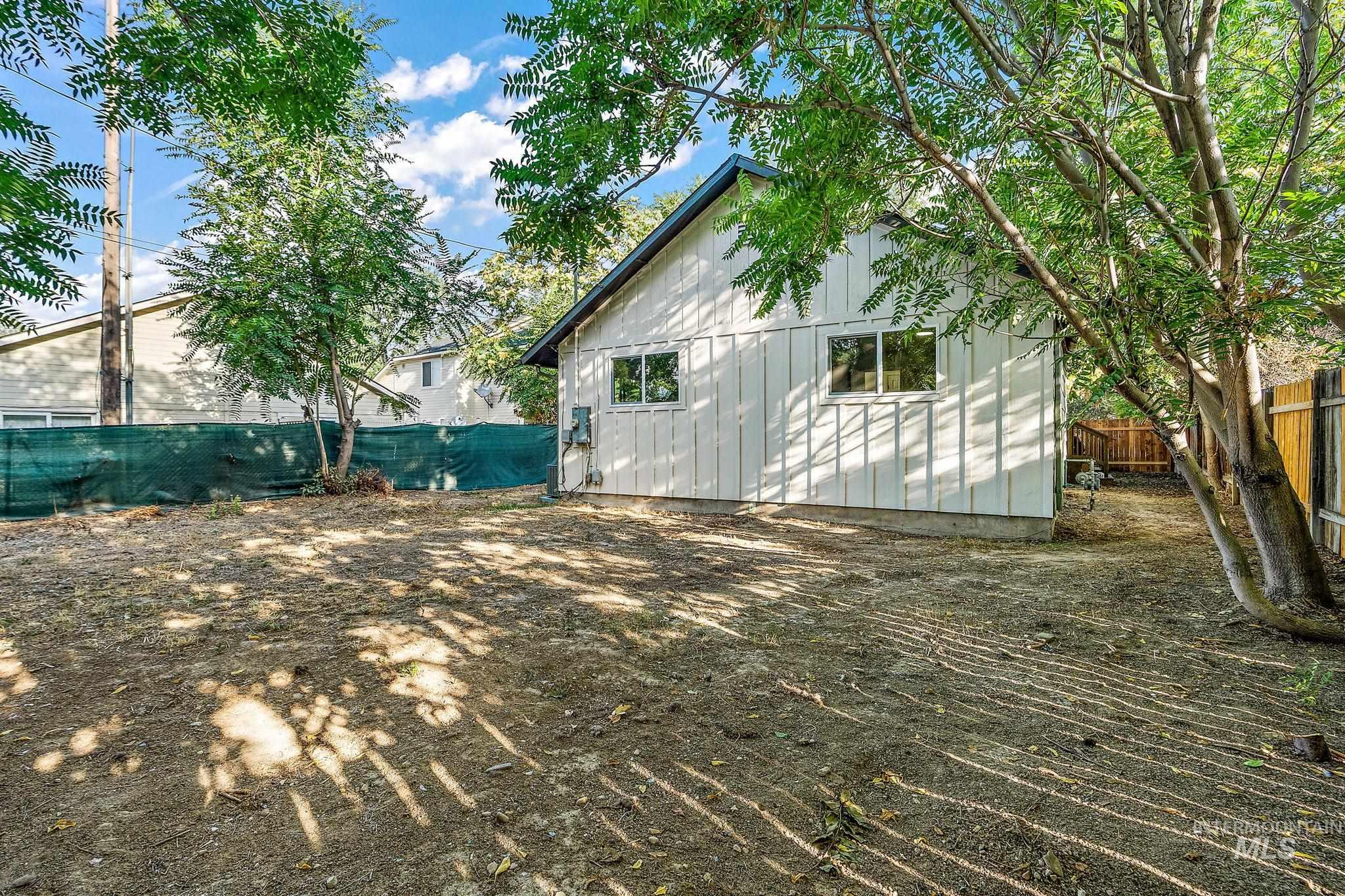 Fenced backyard featuring an outdoor structure
