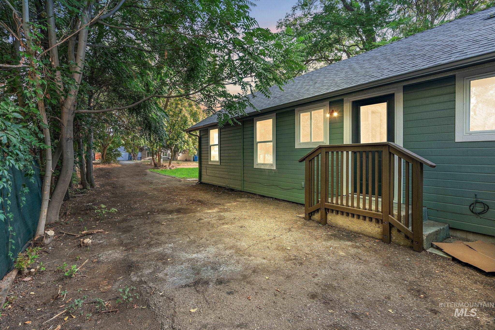 Property exterior at dusk featuring a shingled roof