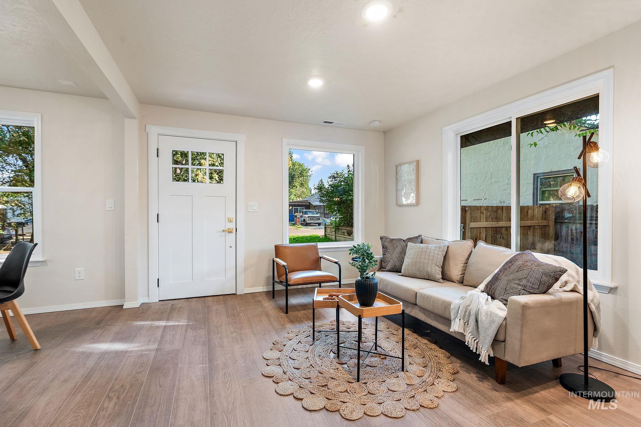 Living area with light wood-style flooring and recessed lighting