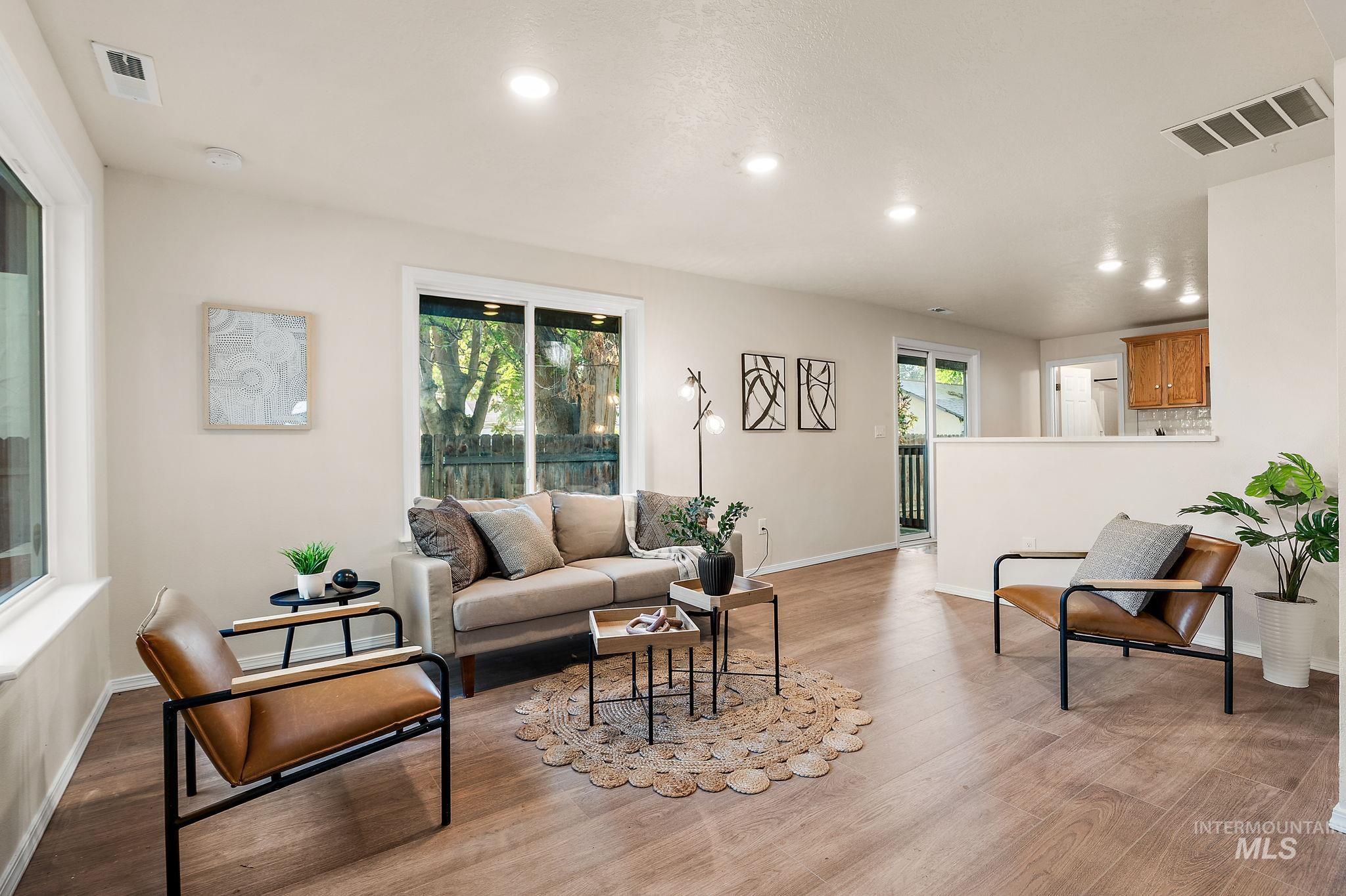 Living area with recessed lighting and light wood finished floors