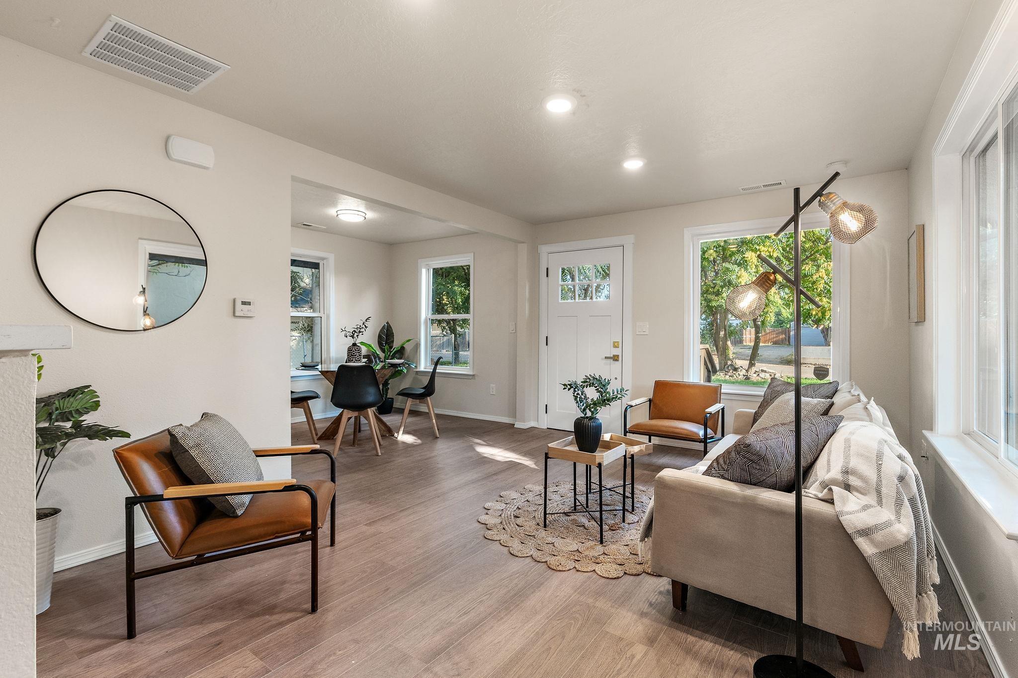 Living area featuring wood finished floors, plenty of natural light, and recessed lighting