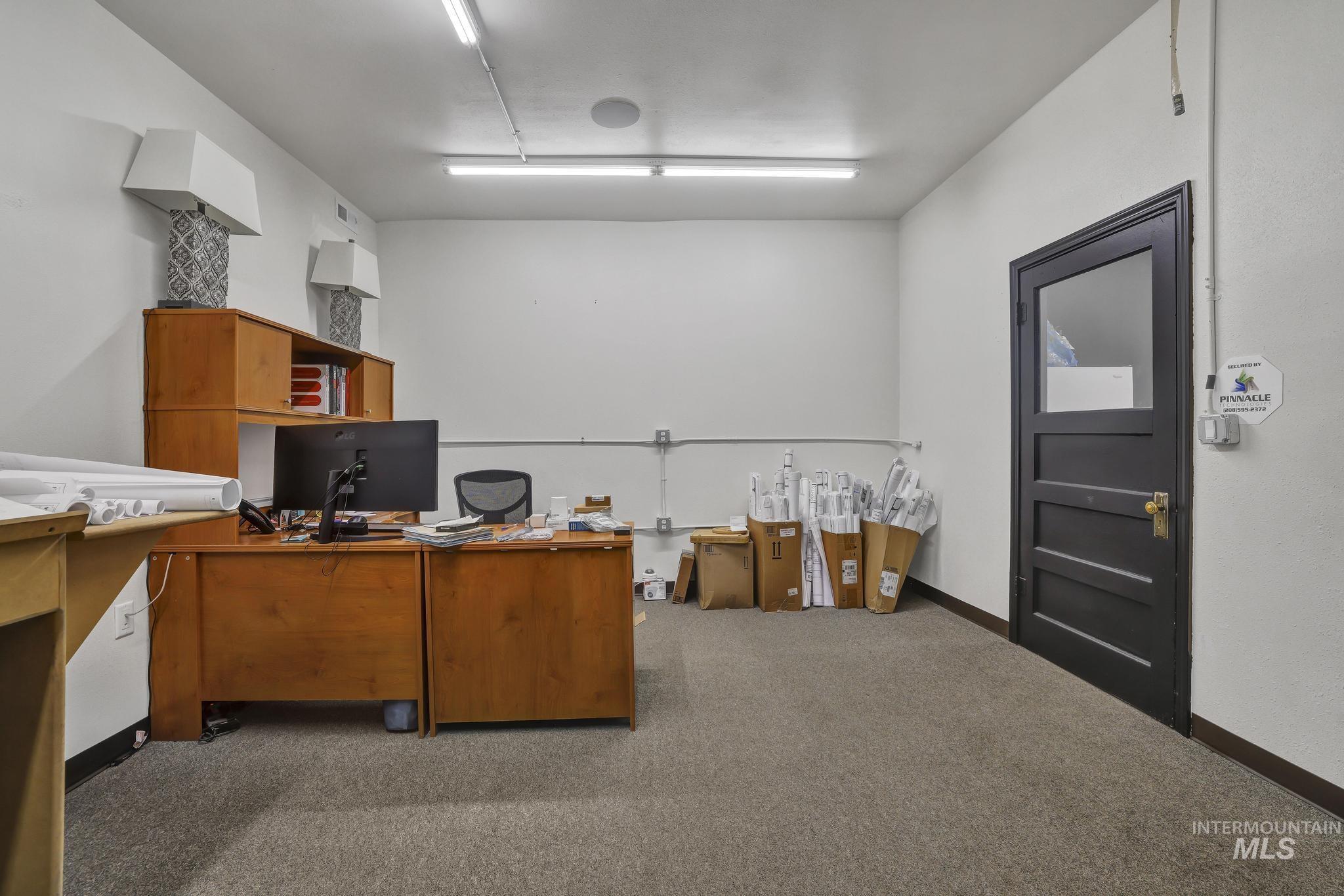 Office area featuring carpet and baseboards