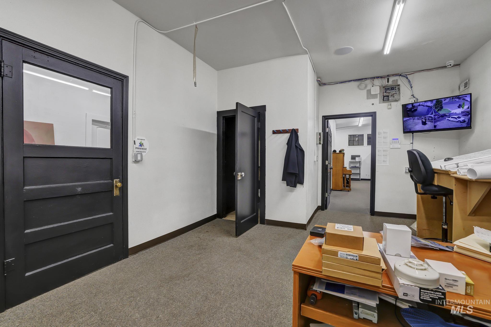 Office with light colored carpet and baseboards
