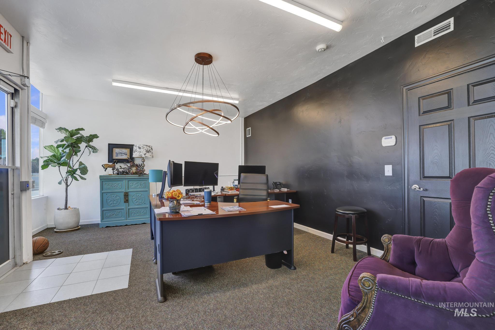 Office space featuring carpet flooring and a chandelier