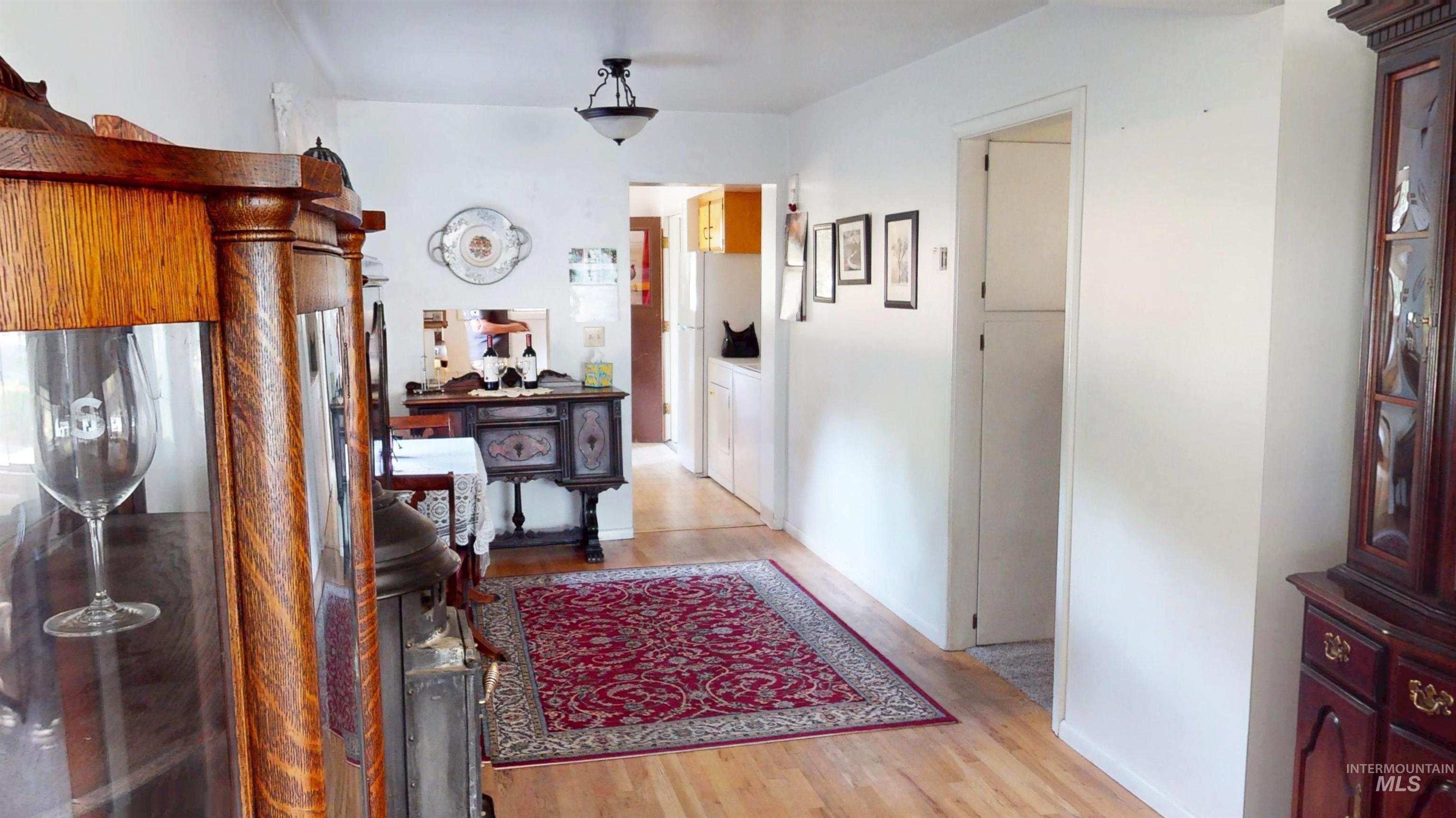 Hall featuring light wood-style flooring and washer / clothes dryer