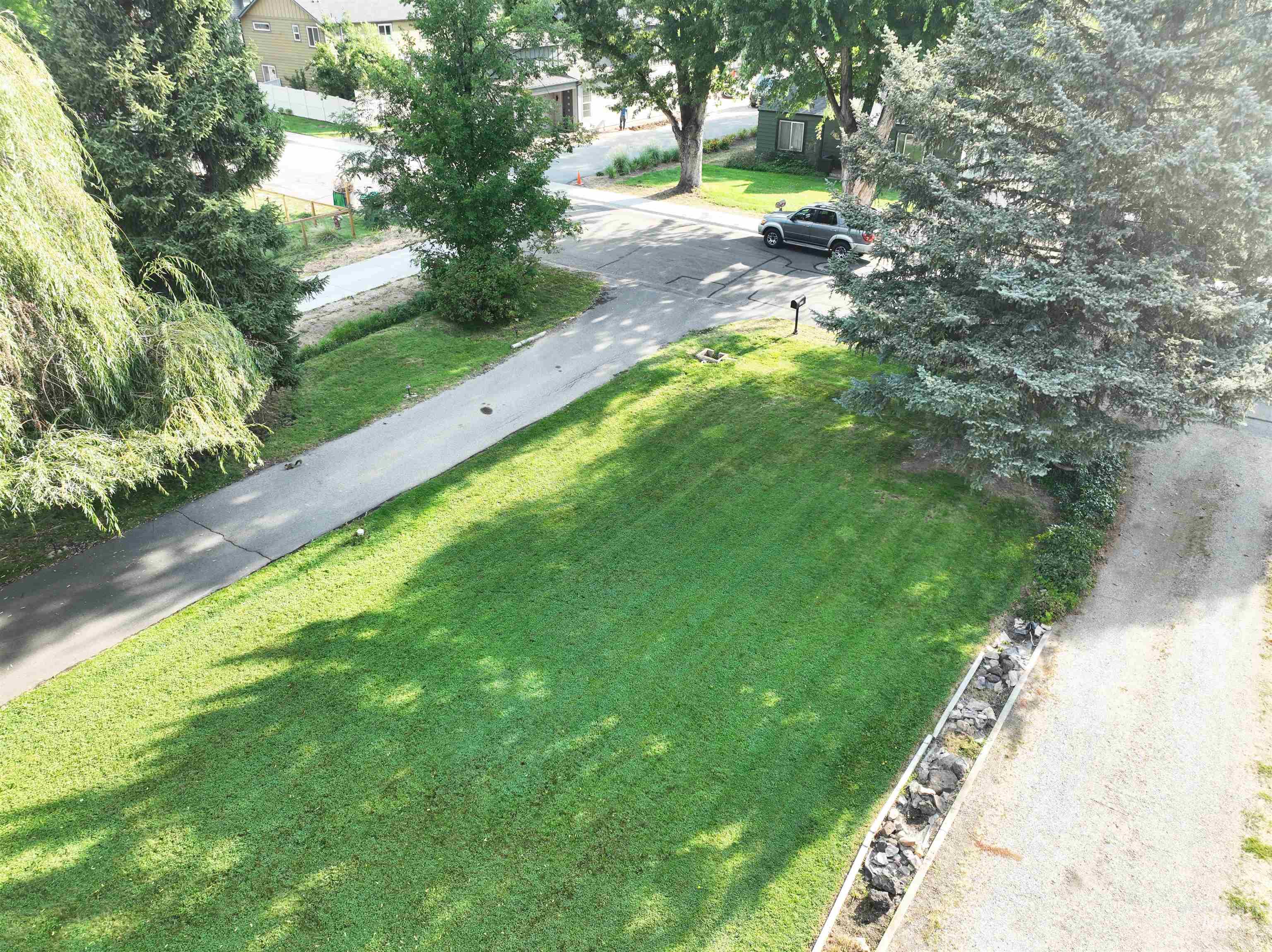 View of home's community with a lawn