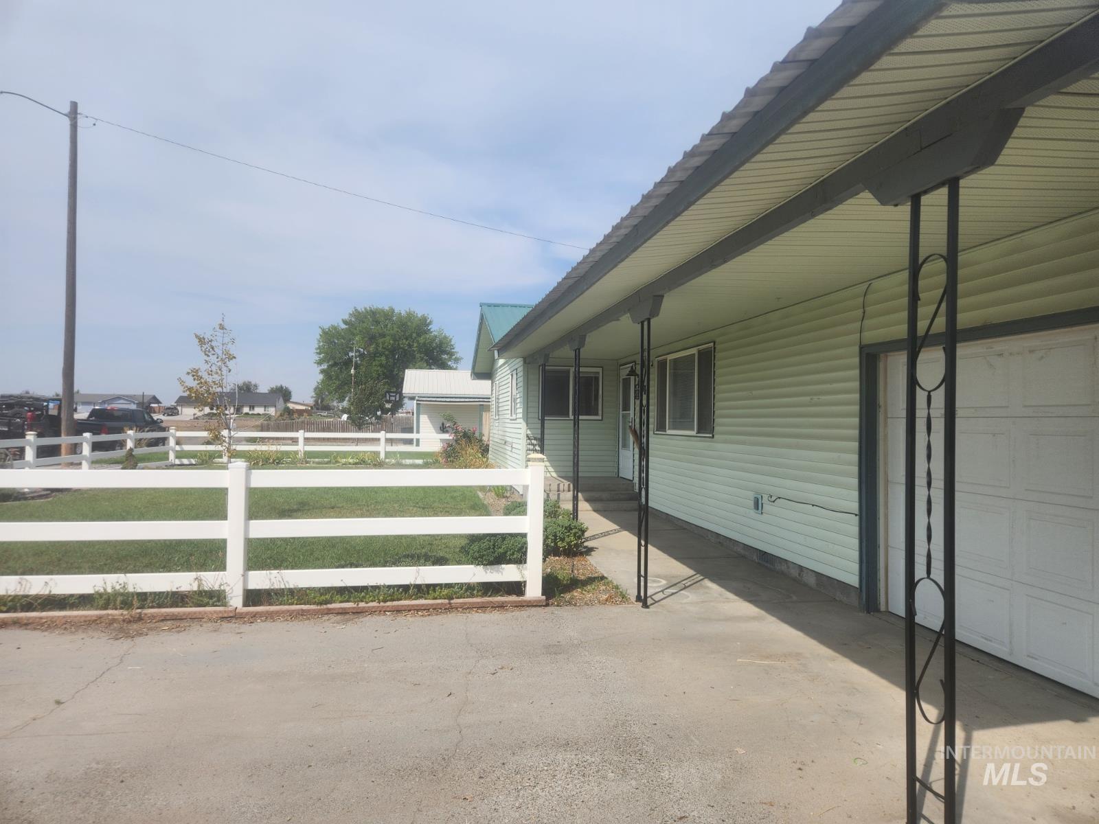 View of home's exterior featuring a garage, crawl space, and a porch
