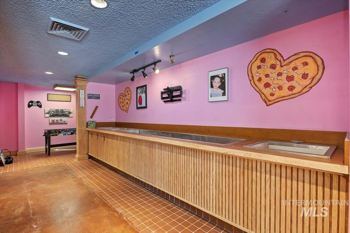Reception featuring a textured ceiling and recessed lighting