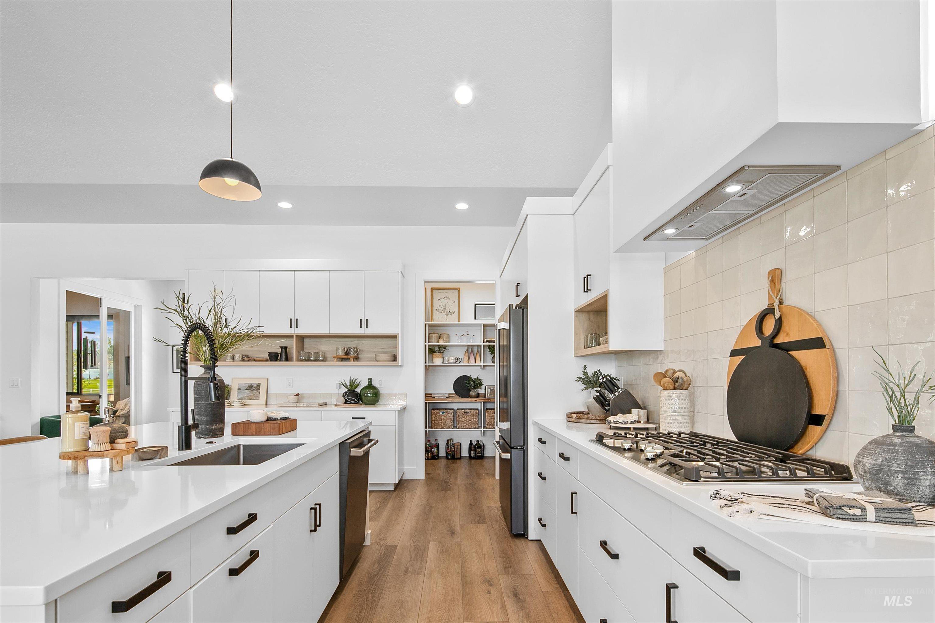 Kitchen featuring white cabinetry, open shelves, pendant lighting, light wood-style floors, and recessed lighting