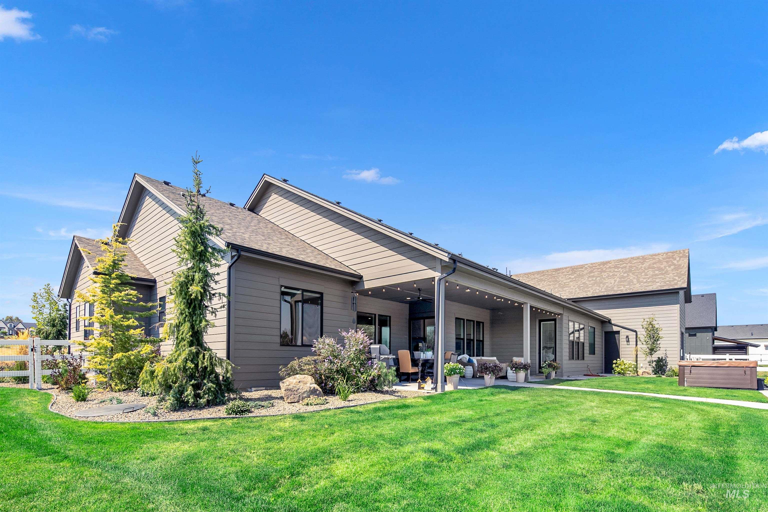 Rear view of property with a patio, outdoor lounge area, and a shingled roof