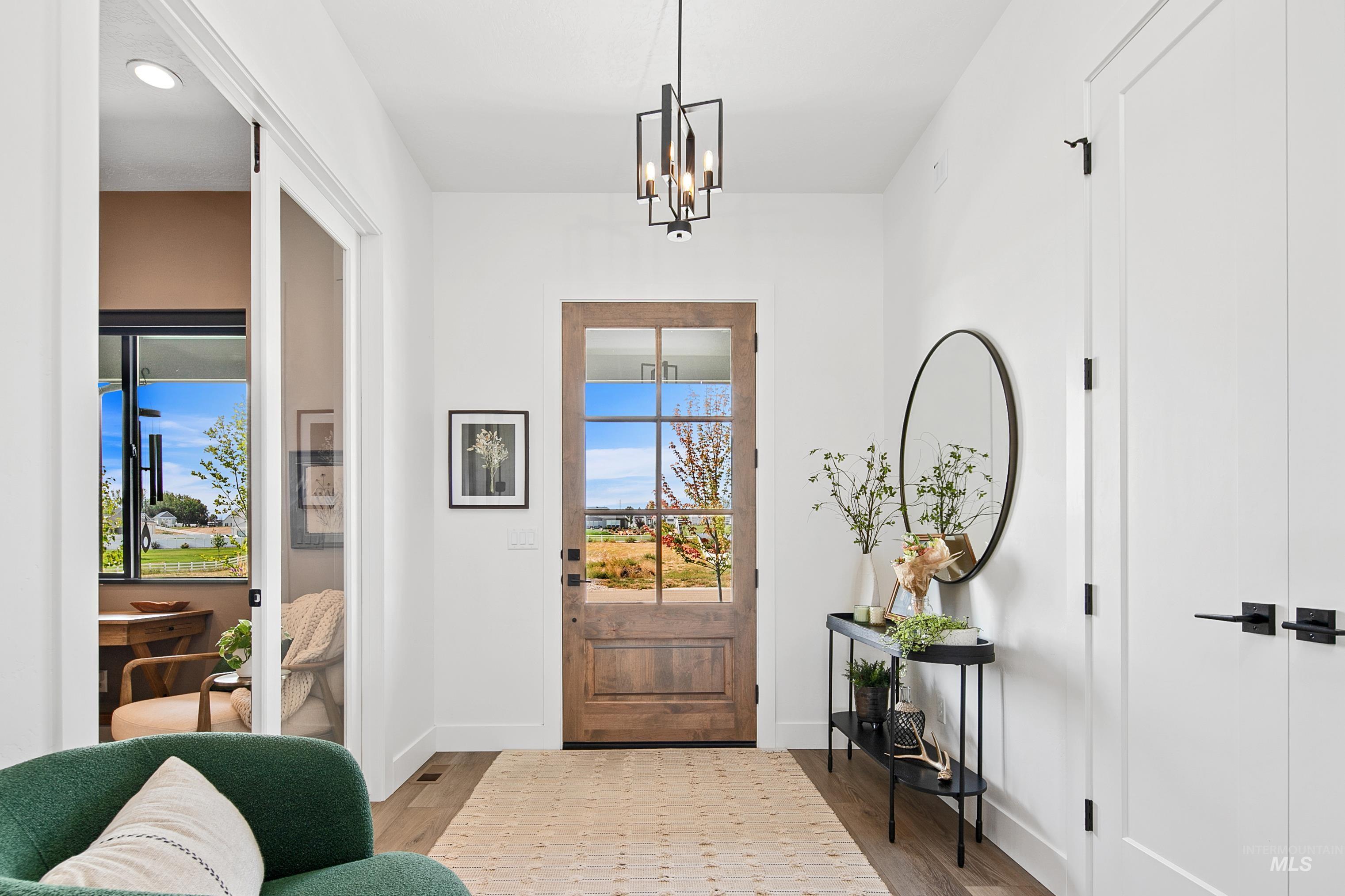 Entryway featuring wood finished floors, a chandelier, and recessed lighting