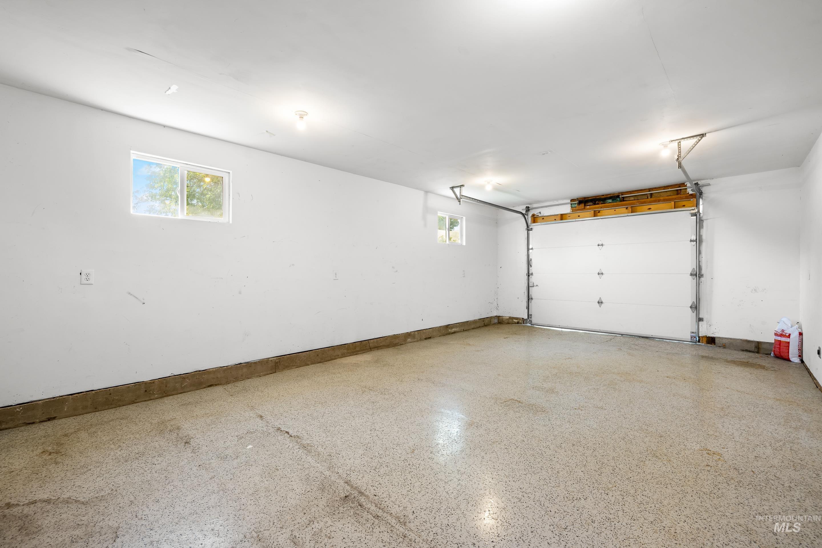 Garage featuring baseboards