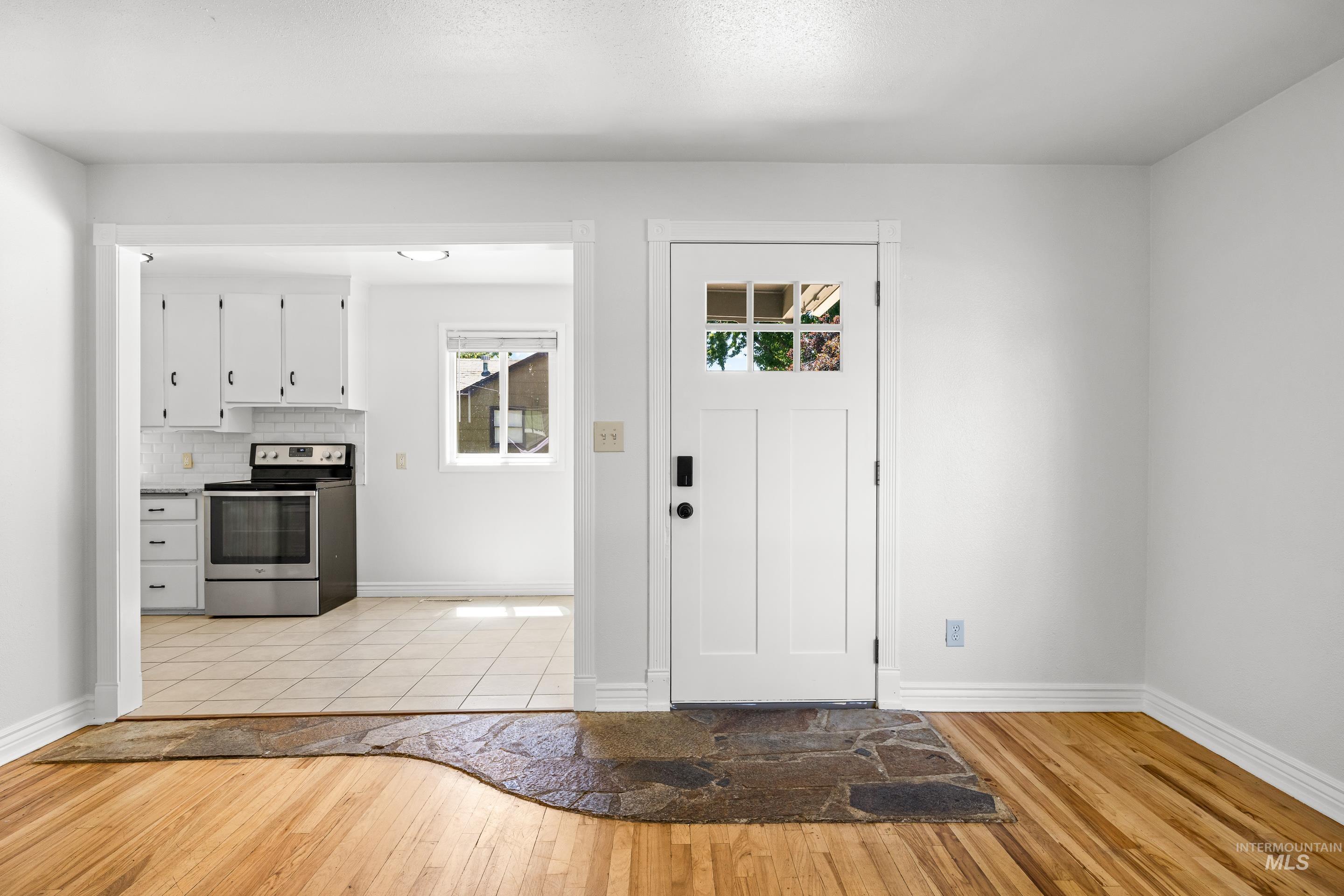 Foyer entrance with light wood-style floors