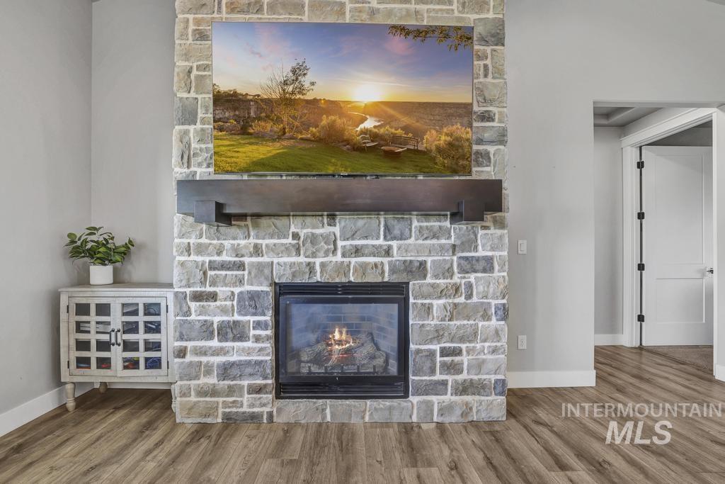 Detailed view of wood finished floors and a fireplace