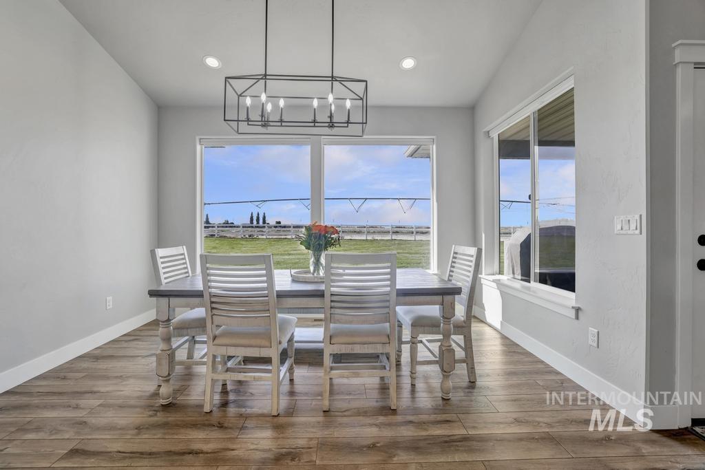 Dining space featuring wood finished floors, a chandelier, and recessed lighting