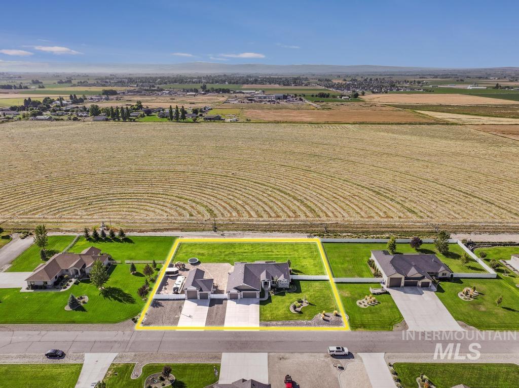 Aerial view of sparsely populated area featuring property boundaries highlighted and farmland