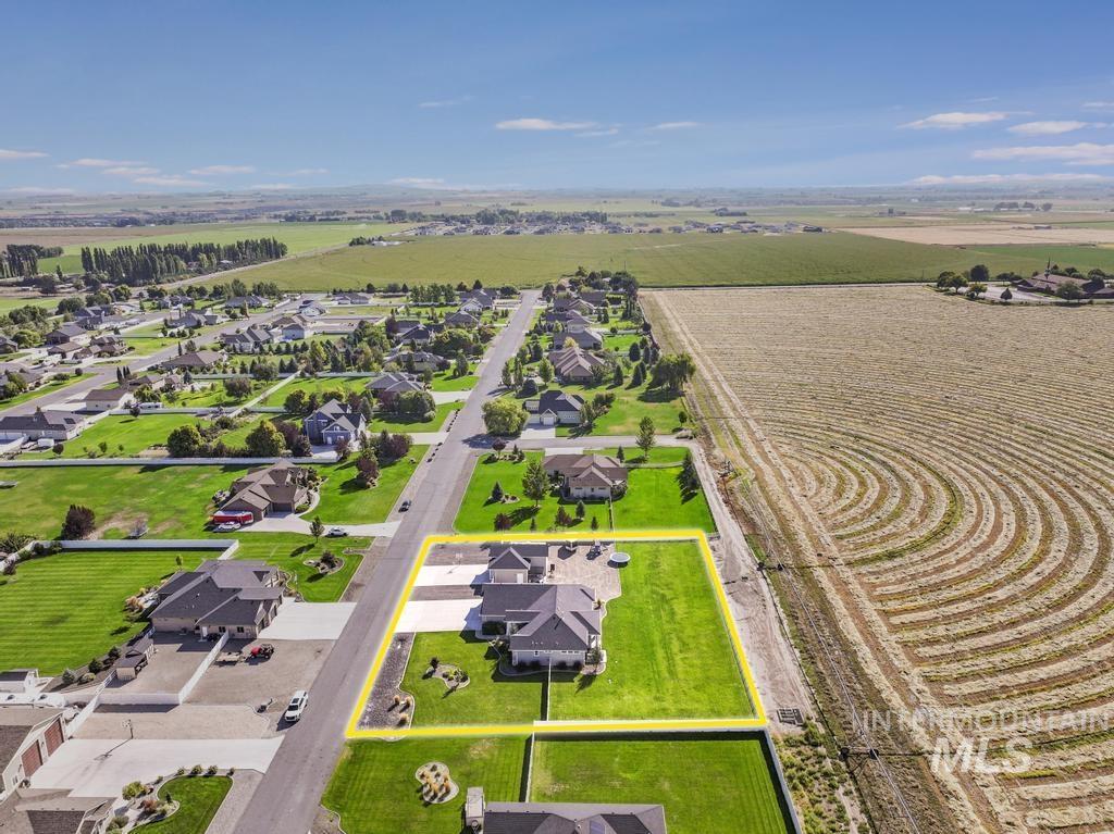 View of rural area featuring nearby suburban area and property parcel outlined