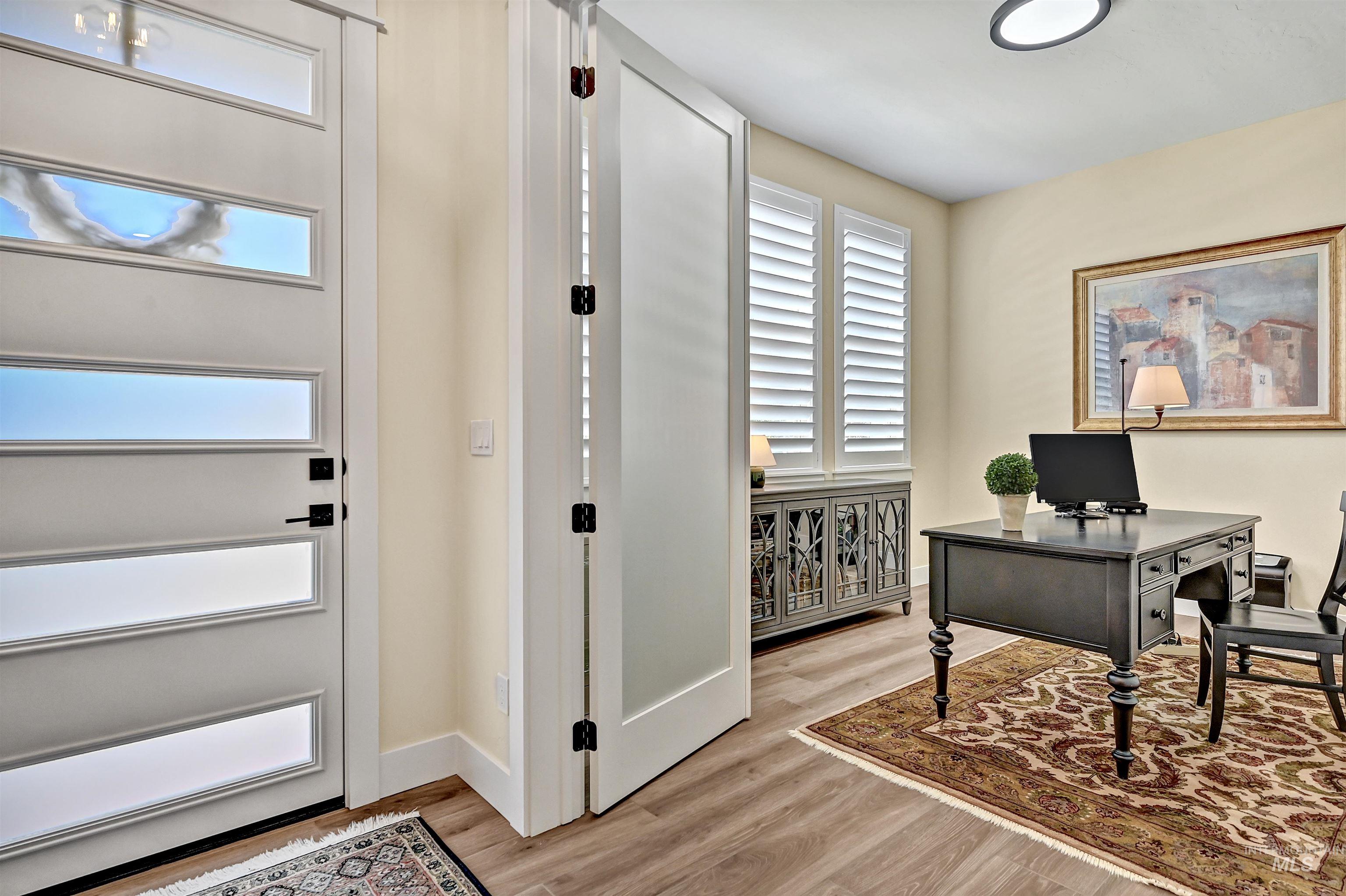 Home office featuring light wood-style floors and baseboards