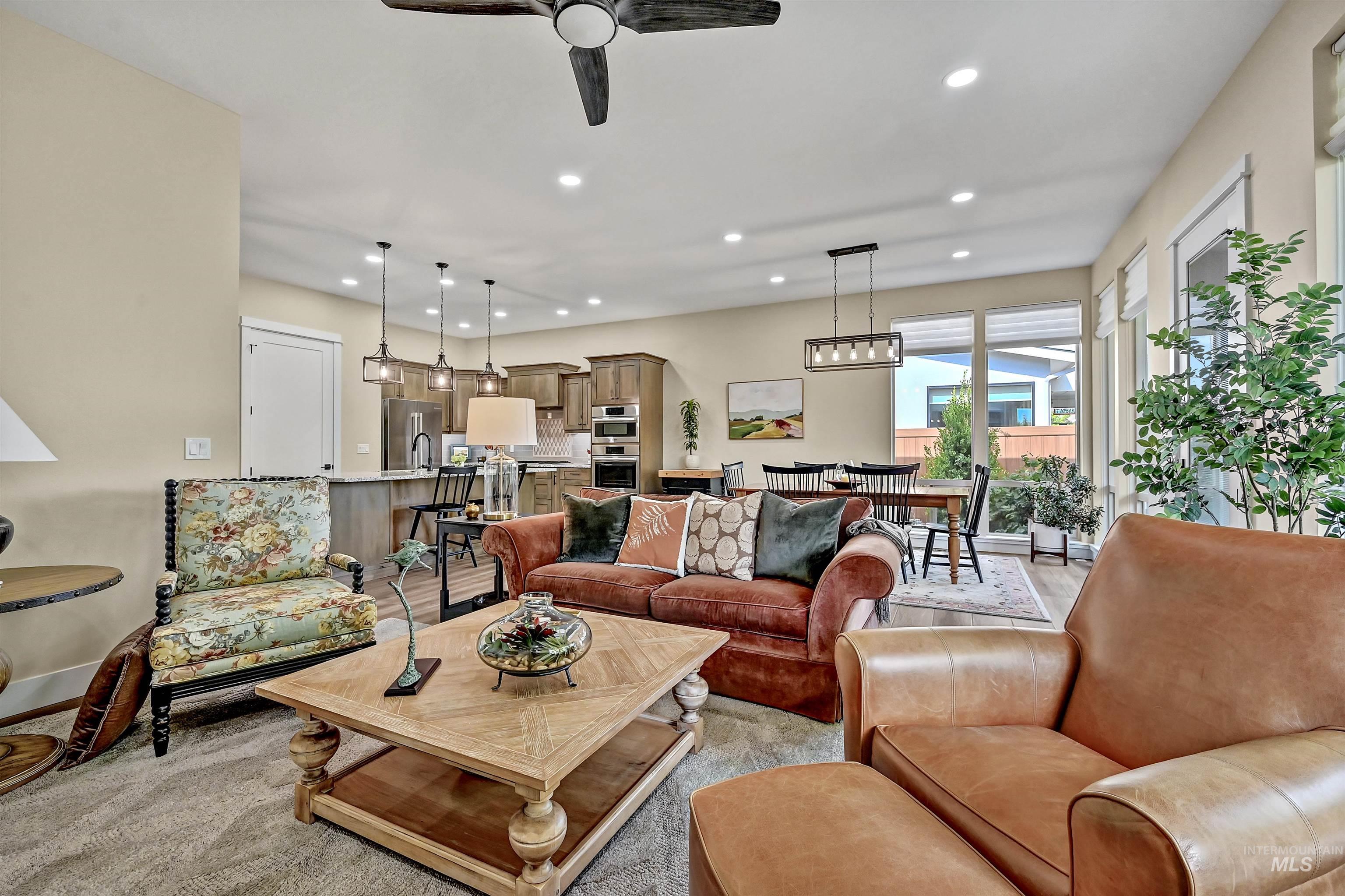 Living room featuring recessed lighting, ceiling fan, and light carpet