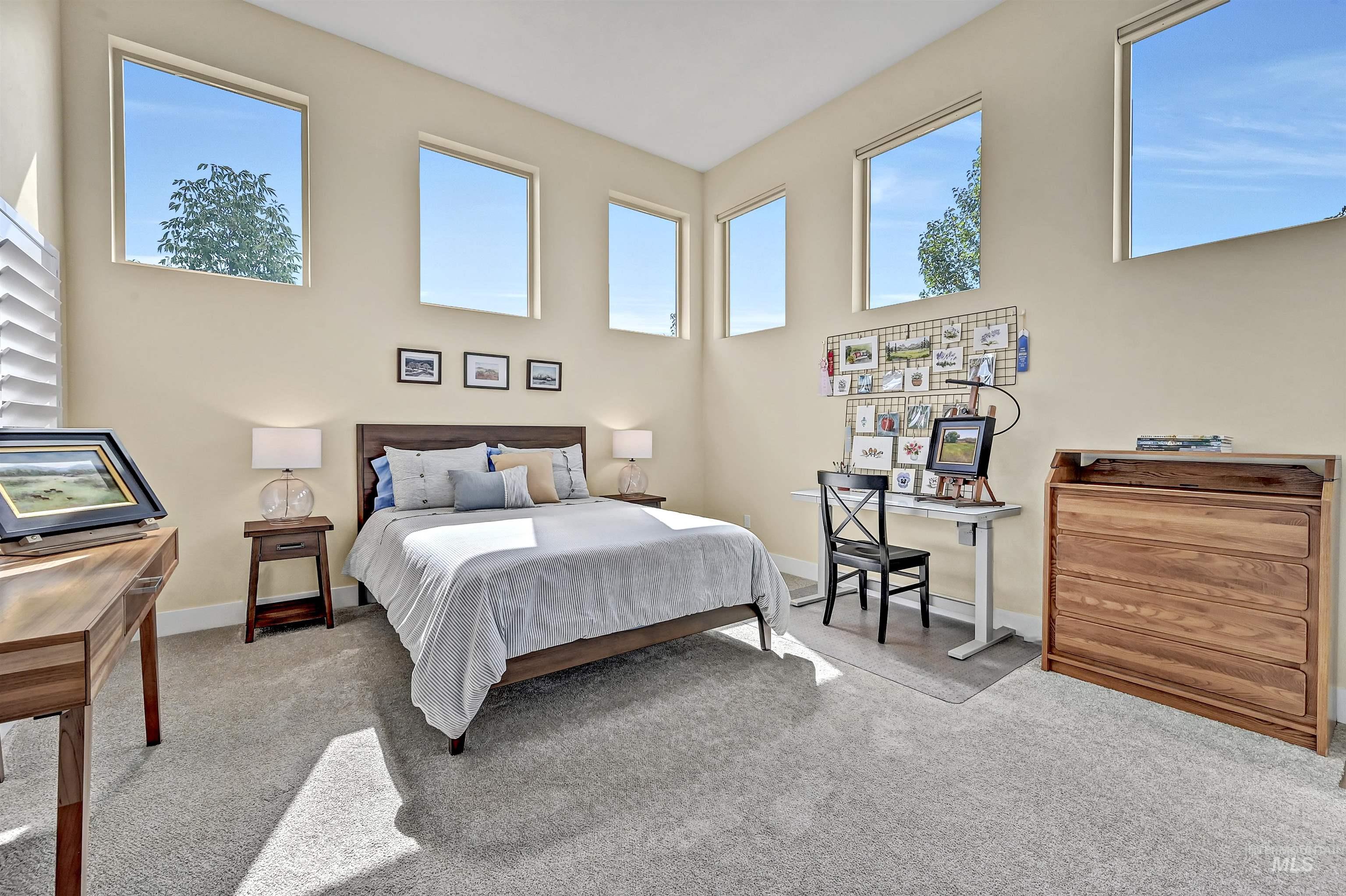 Bedroom featuring carpet floors and baseboards